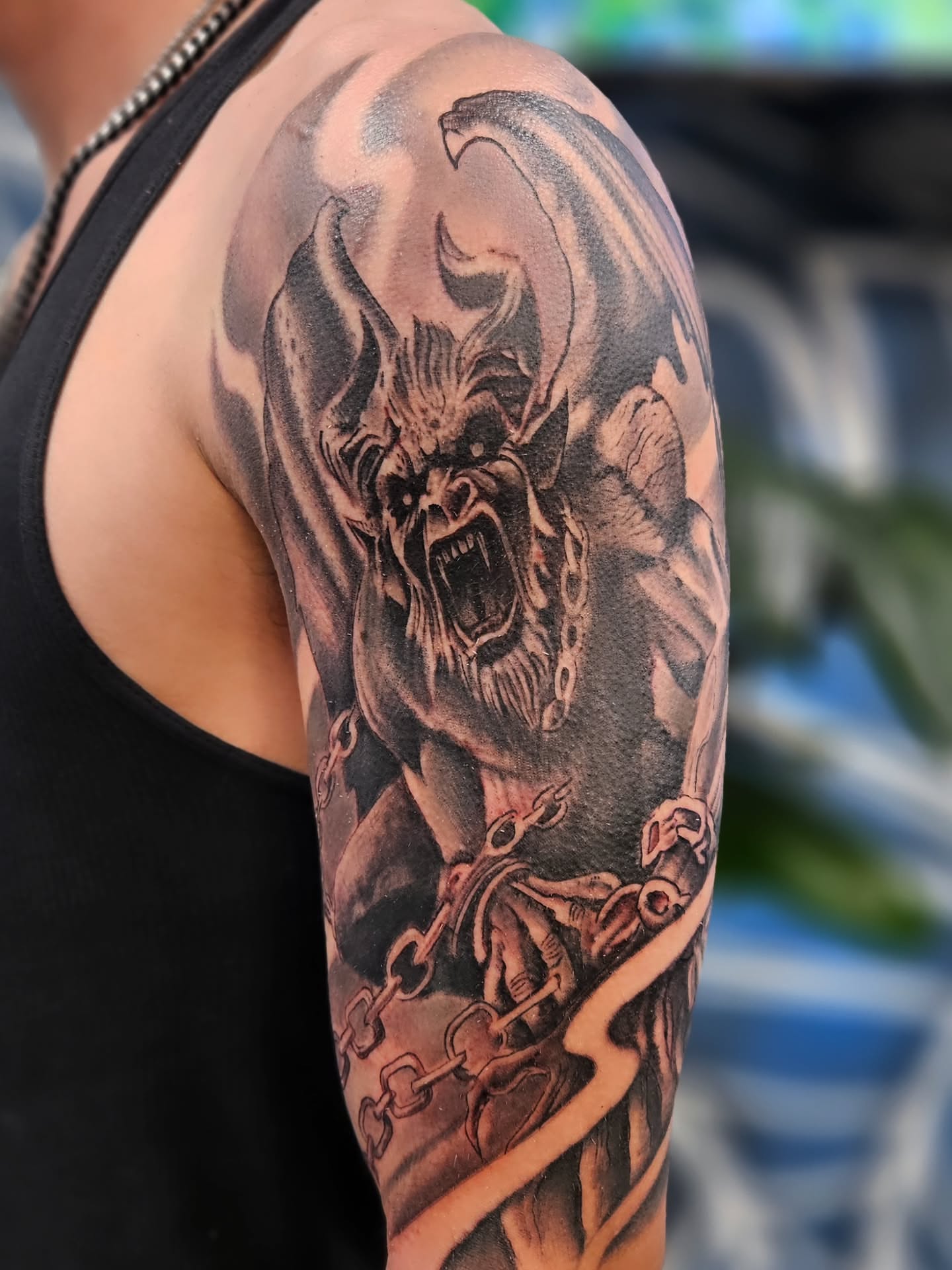 Demon realism tattoo on the upper arm by Jo'el Acoba