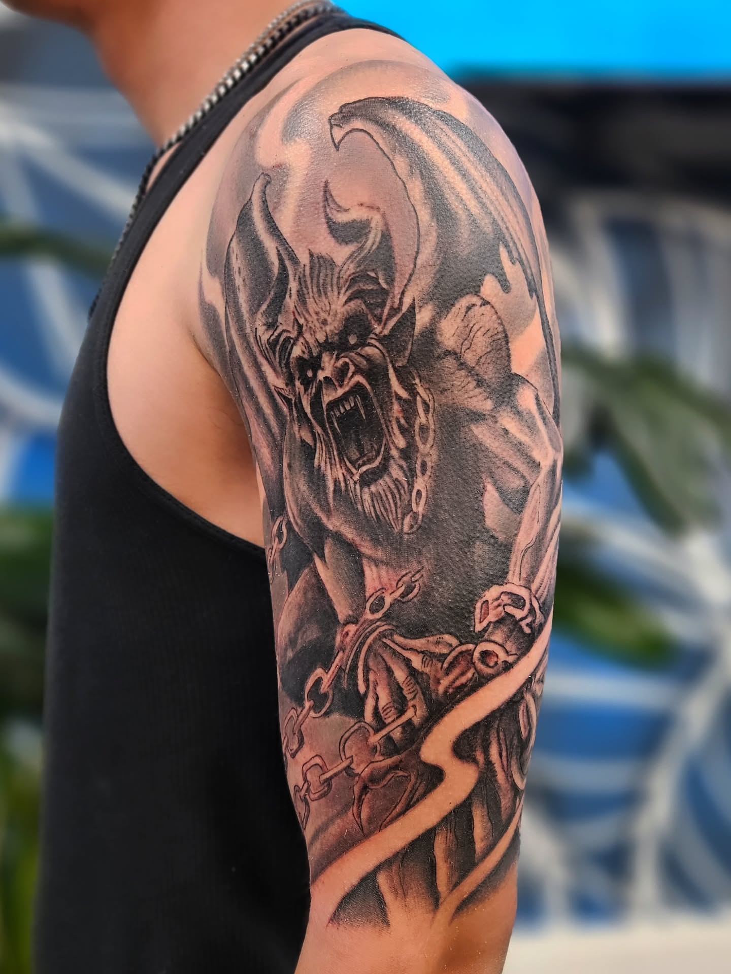 Demon realism tattoo on the forearm by Jo'el Acoba