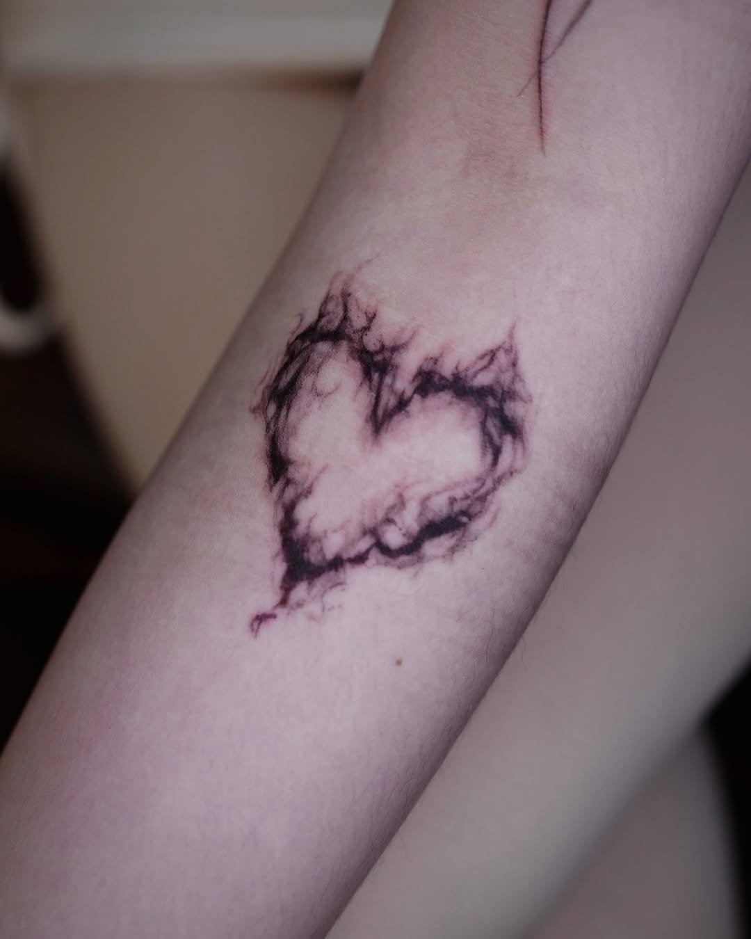 Heart smoke surrealism tattoo on the forearm by @ashencoil