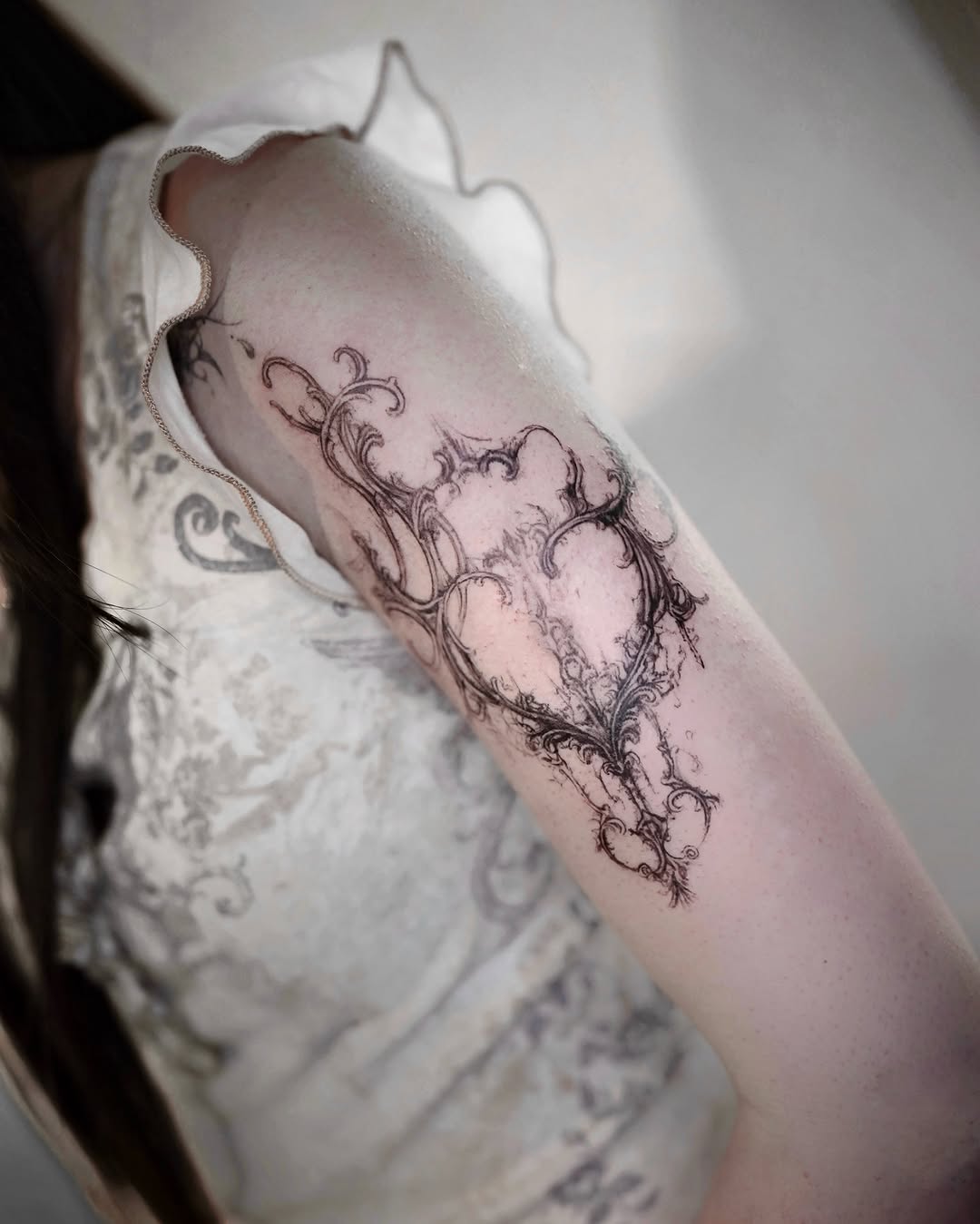 Ornamental frame with floral elements cyber sigilism tattoo on the forearm by @ashencoil