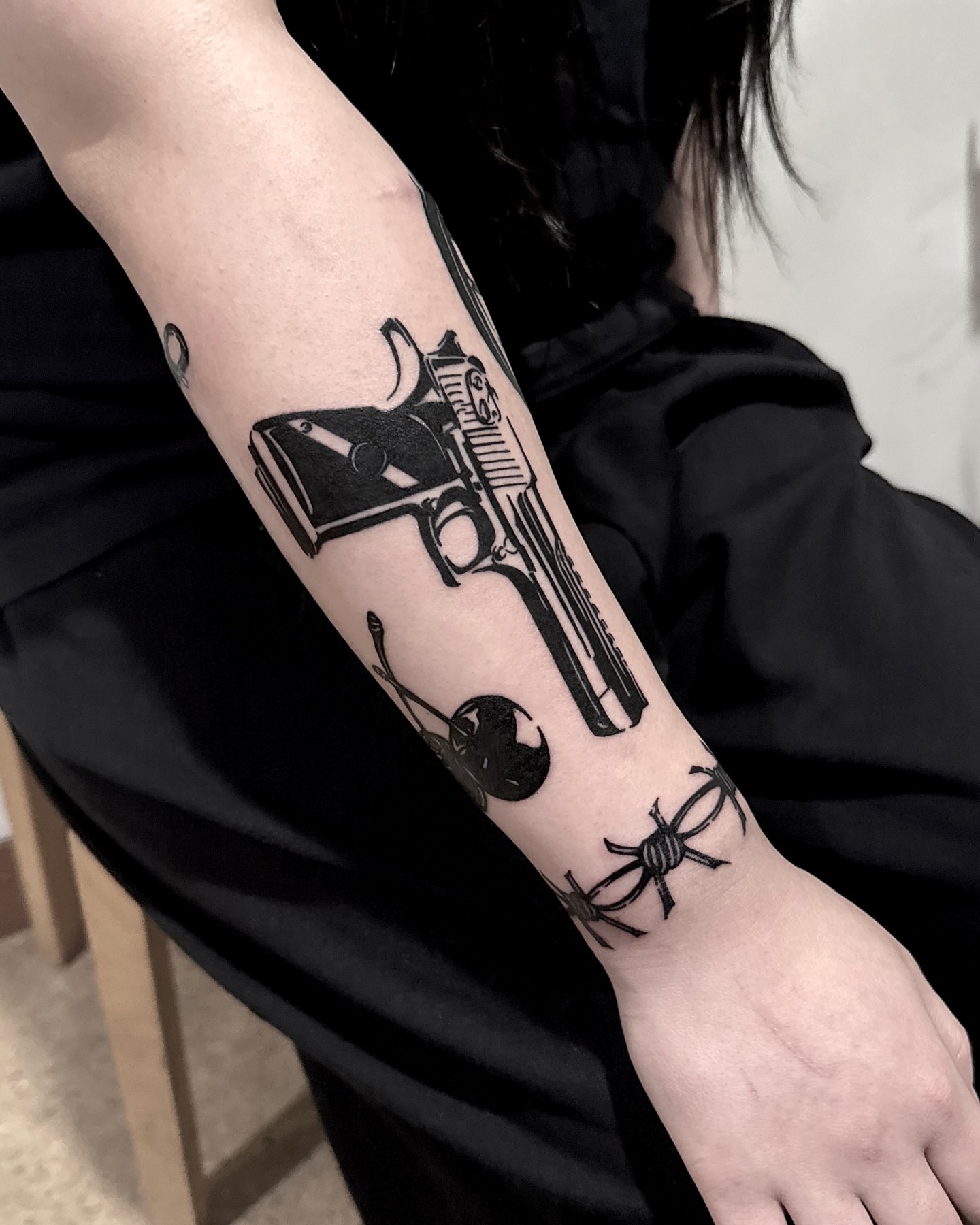 Gun and spider black and grey tattoo on the forearm by 블랙워크 로니  blackwork roni