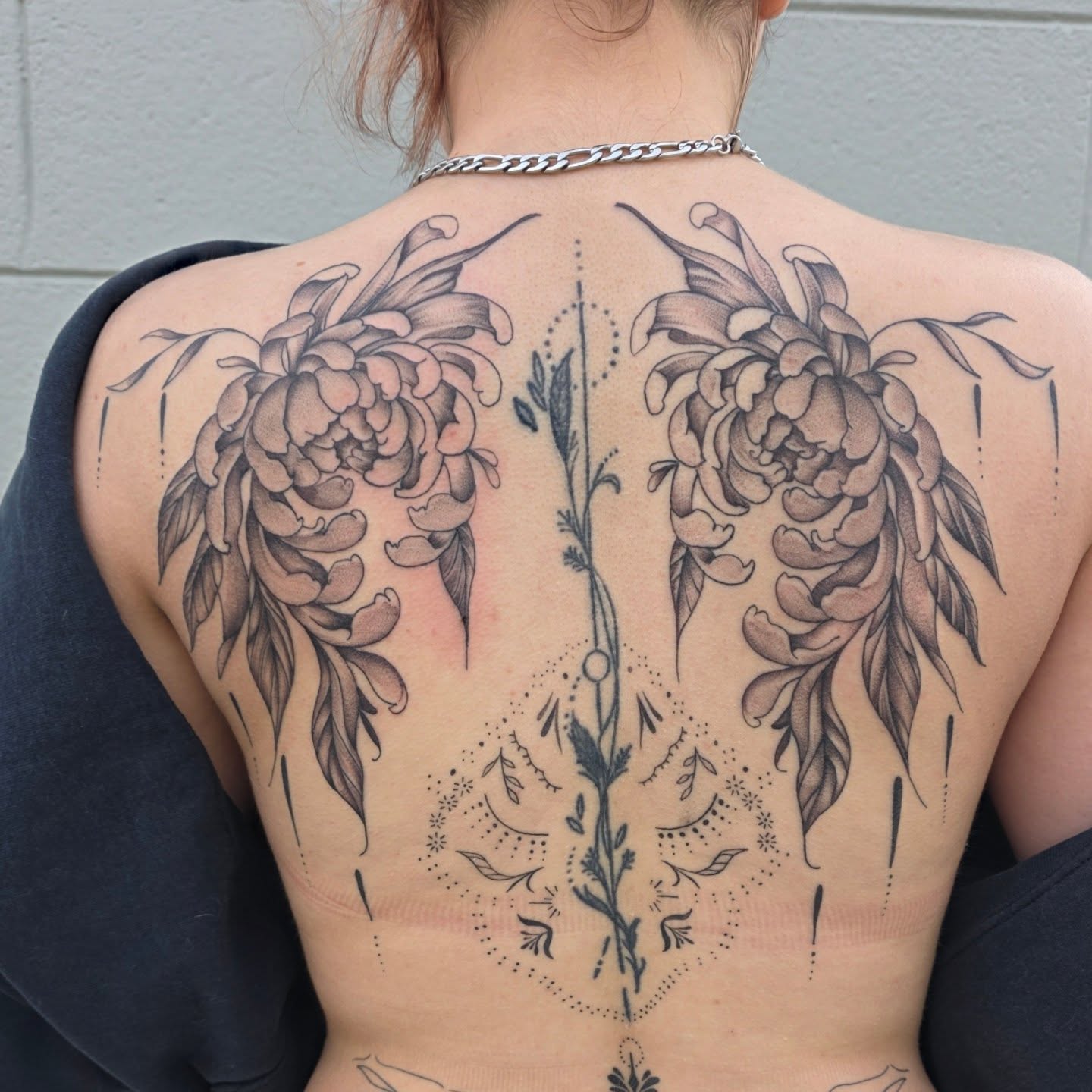 Floral wings dotwork tattoo on the back by Maggie