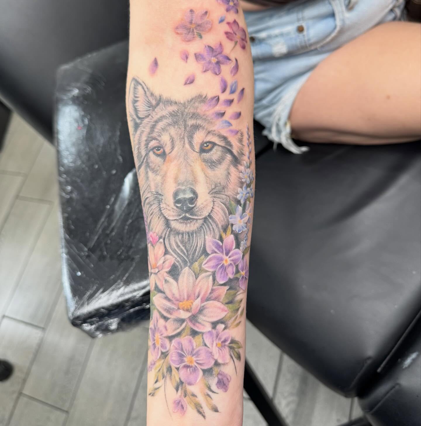 Wolf and flowers realism tattoo on the forearm by Joey Flaherty