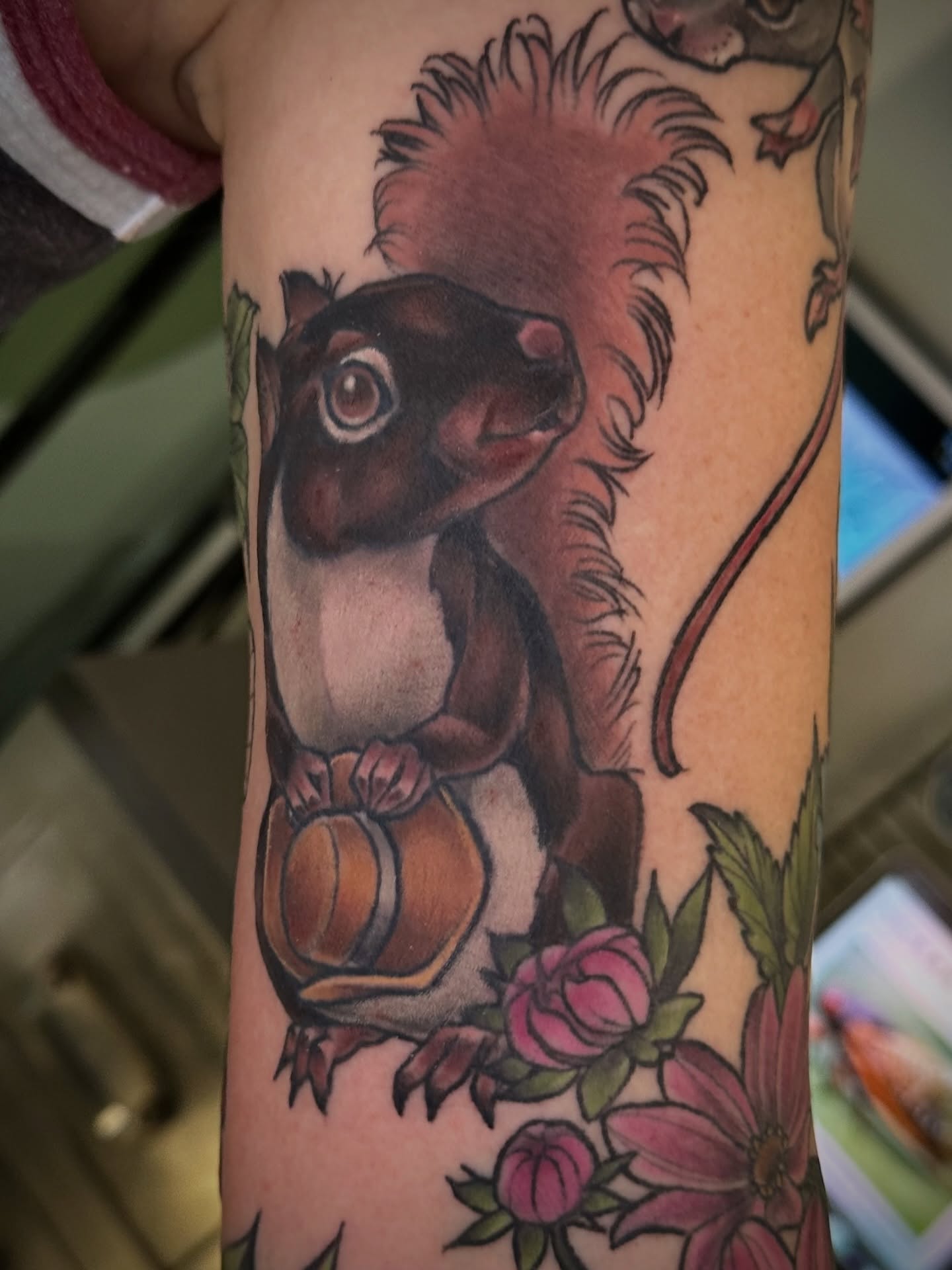 Squirrel and flowers American traditional tattoo on the forearm by Katie Hutchins, Dayton, Ohio
