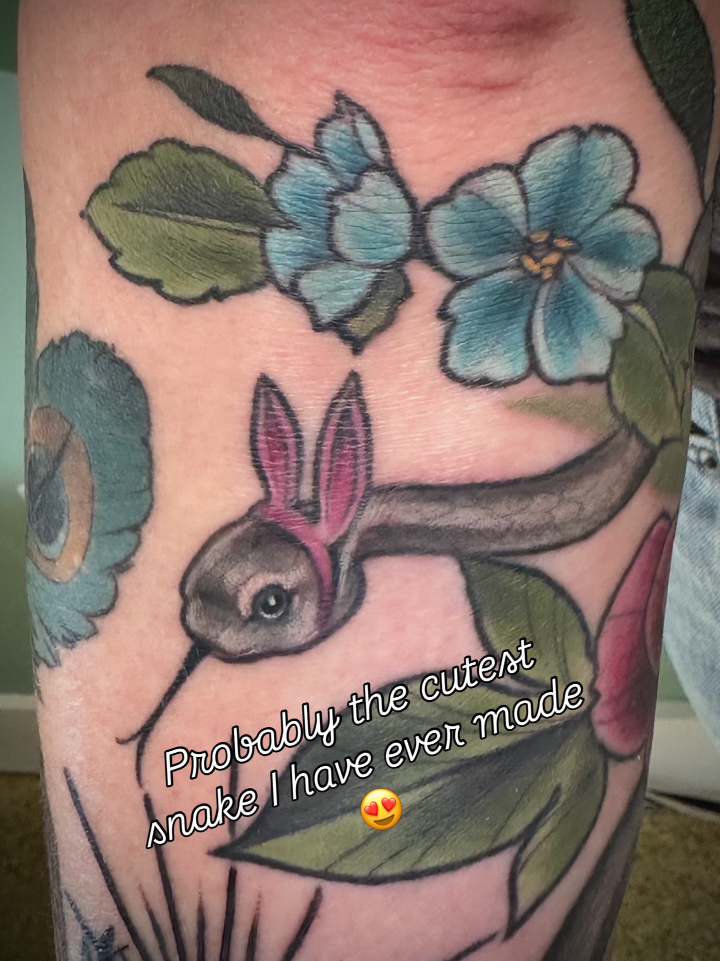 Snake and flowers American traditional tattoo on the forearm by Katie Hutchins, Dayton, Ohio
