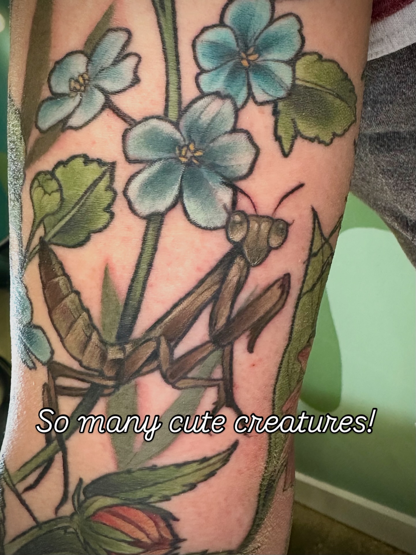Mantis and flowers realism tattoo on the forearm by Katie Hutchins, Dayton, Ohio