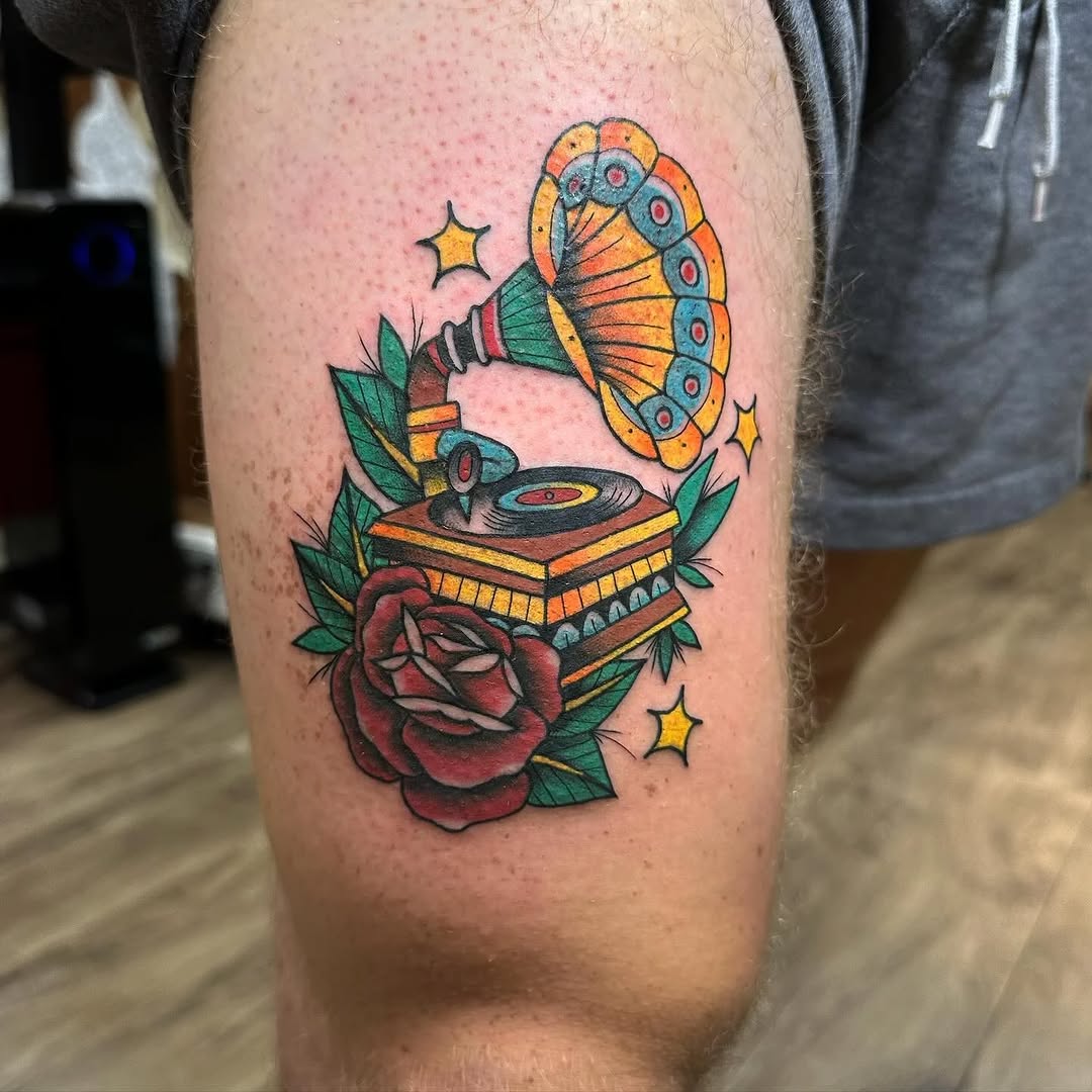 Vintage record player and rose neo-traditional tattoo on the thigh by Greyson Heidenreich