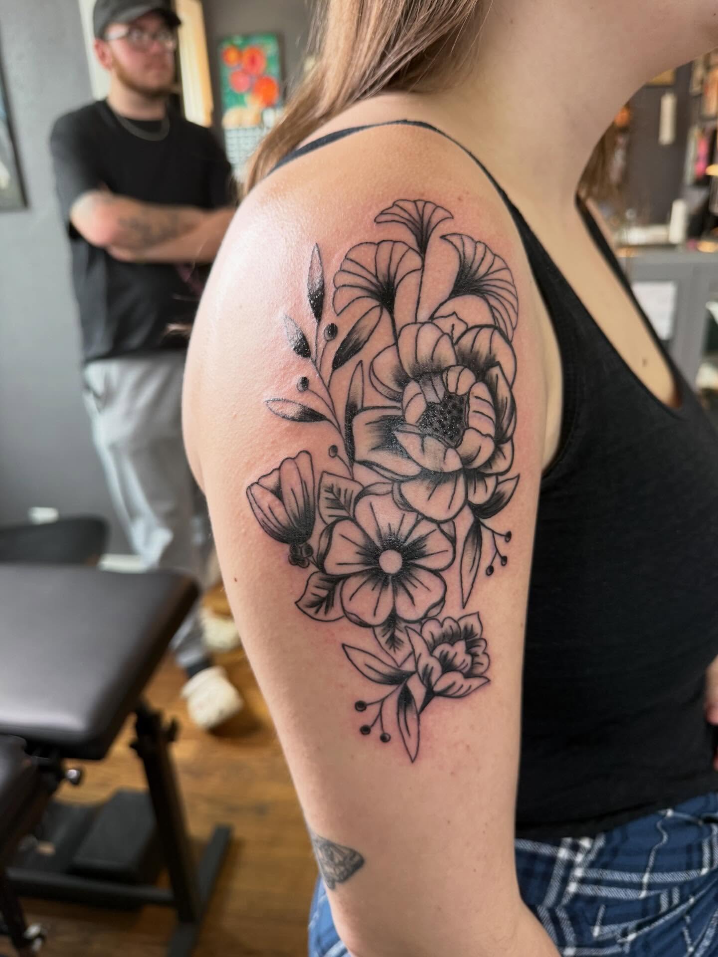 Floral bouquet black and grey tattoo on the shoulder by Jillian Pardy