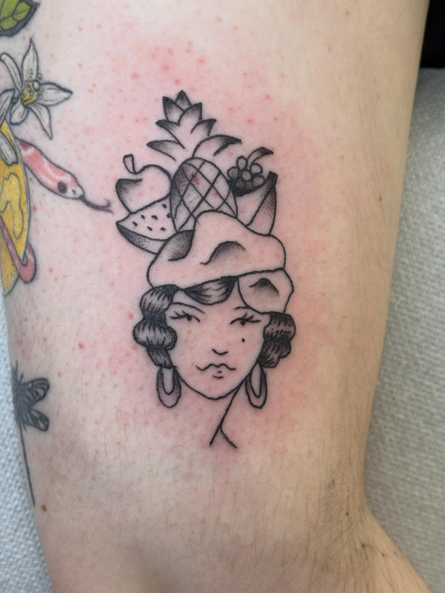 Fruit and woman black and grey tattoo on the forearm by Topher Belmont