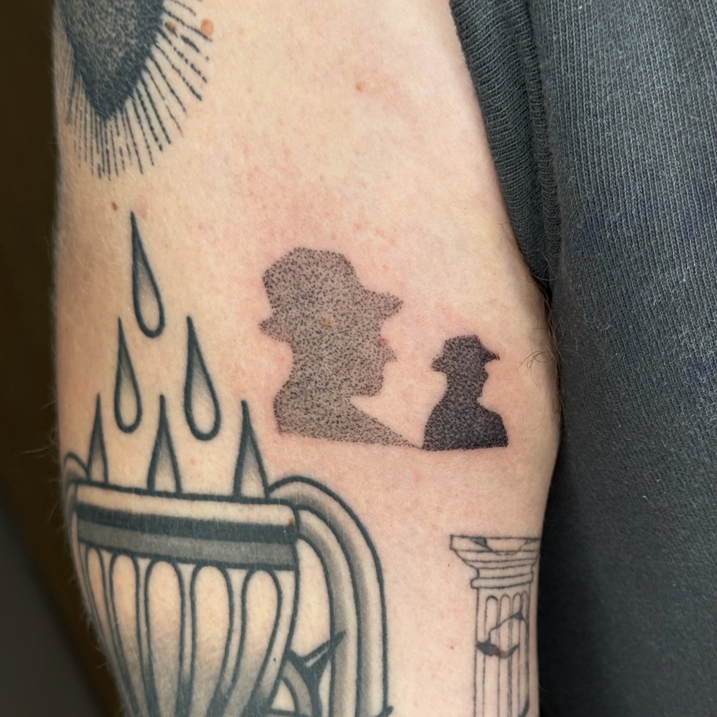 Coffee cup with rain and silhouettes dotwork tattoo on the forearm by Joint Killer