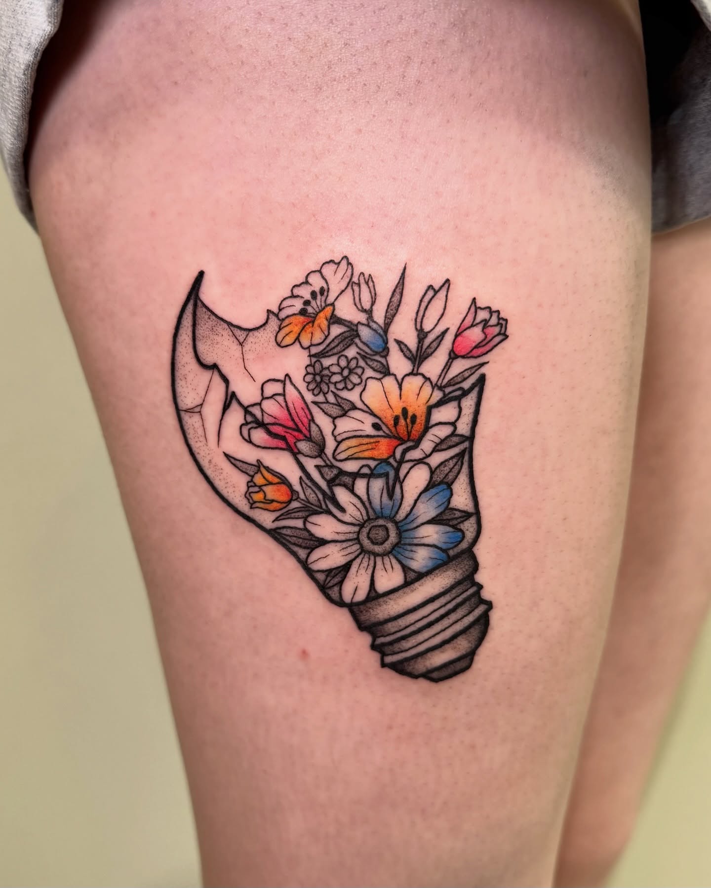 Flower bouquet dotwork tattoo on the thigh by Eden Allen