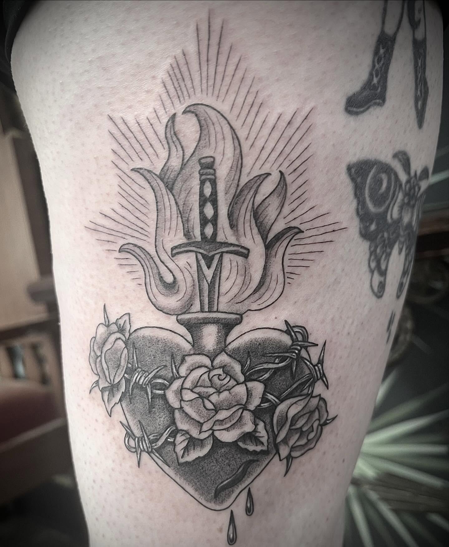 Heart with dagger and roses American traditional tattoo on the thigh by Natalie Phillips, Oakland, California