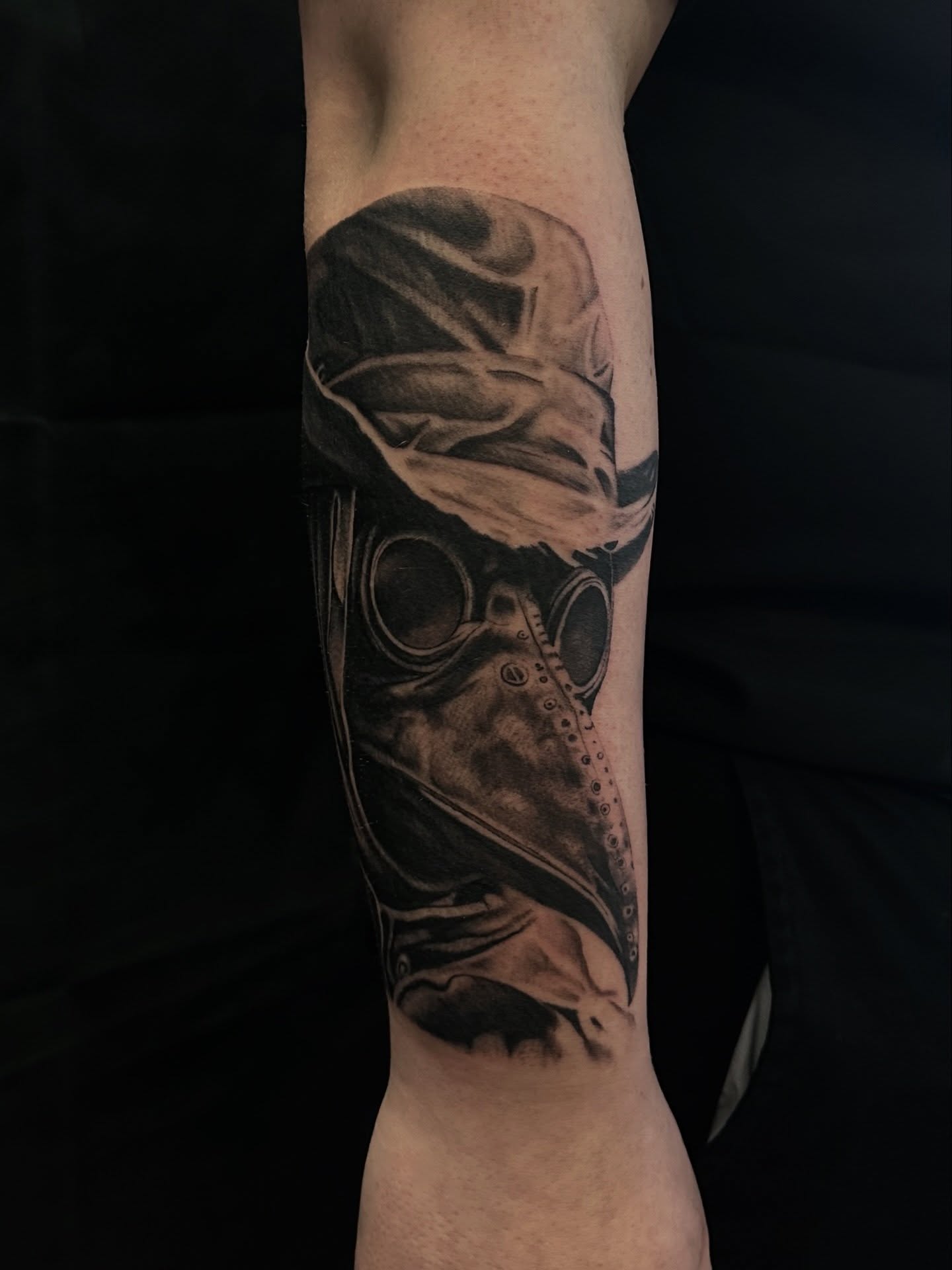 Plague doctor mask realism tattoo on the forearm by Matt Kearney