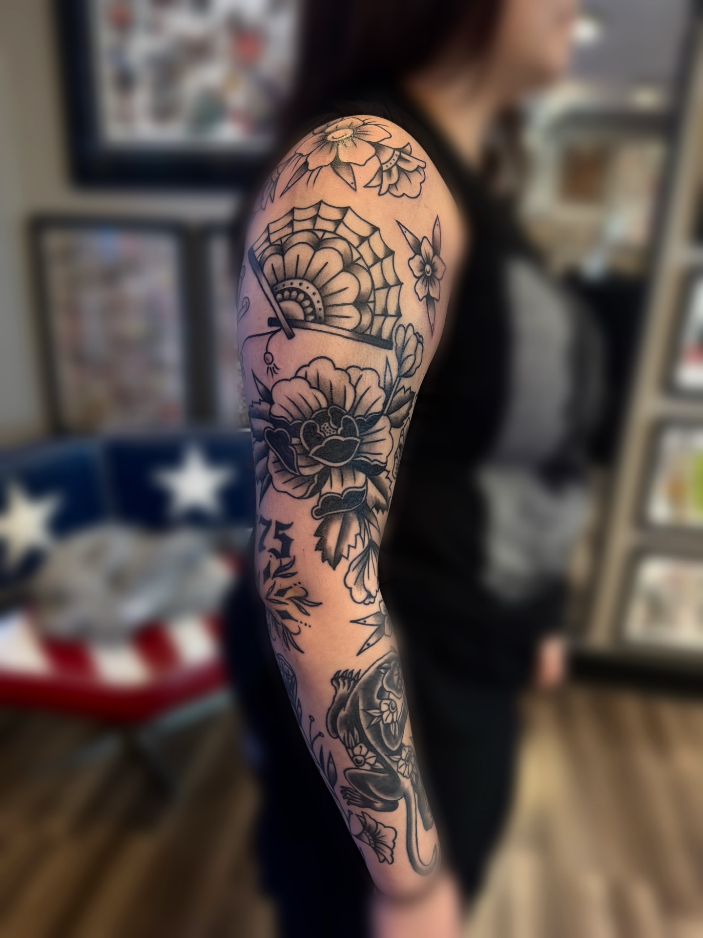 Floral and spiderweb American traditional tattoo on the forearm by juice🕷tattoo artist
