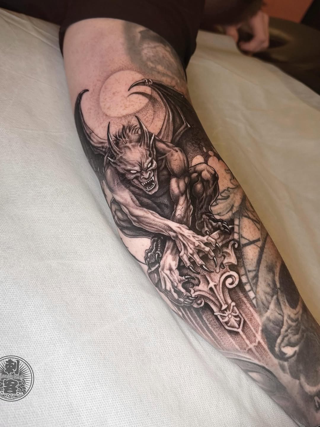 Gargoyle with sword realism tattoo on the forearm by Duo