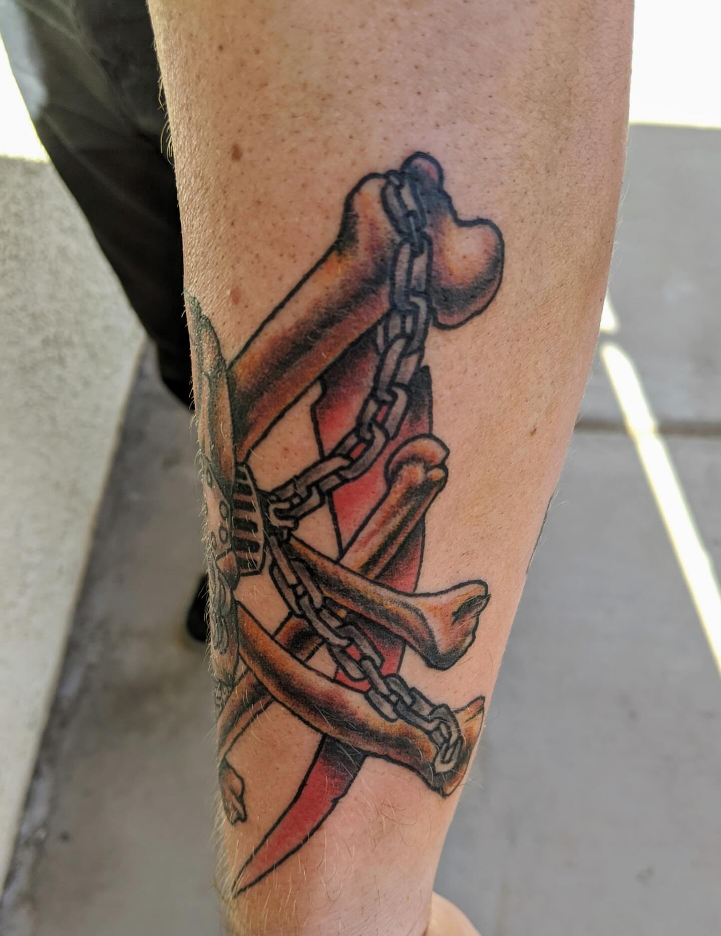 Chains and bones American traditional tattoo on the forearm by Columbus tattoo artist