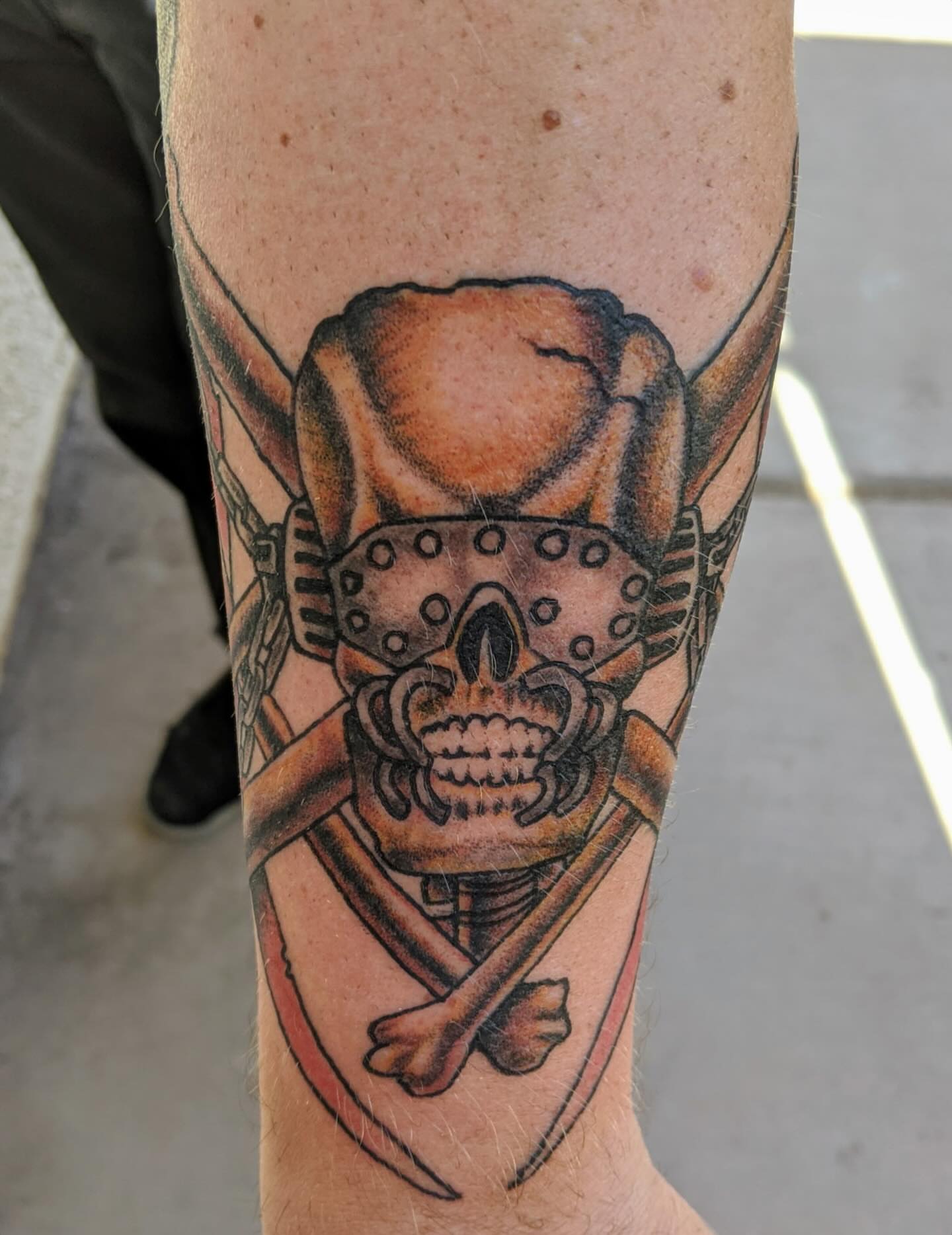 Skull and crossbones black and grey tattoo on the forearm by Columbus tattoo artist
