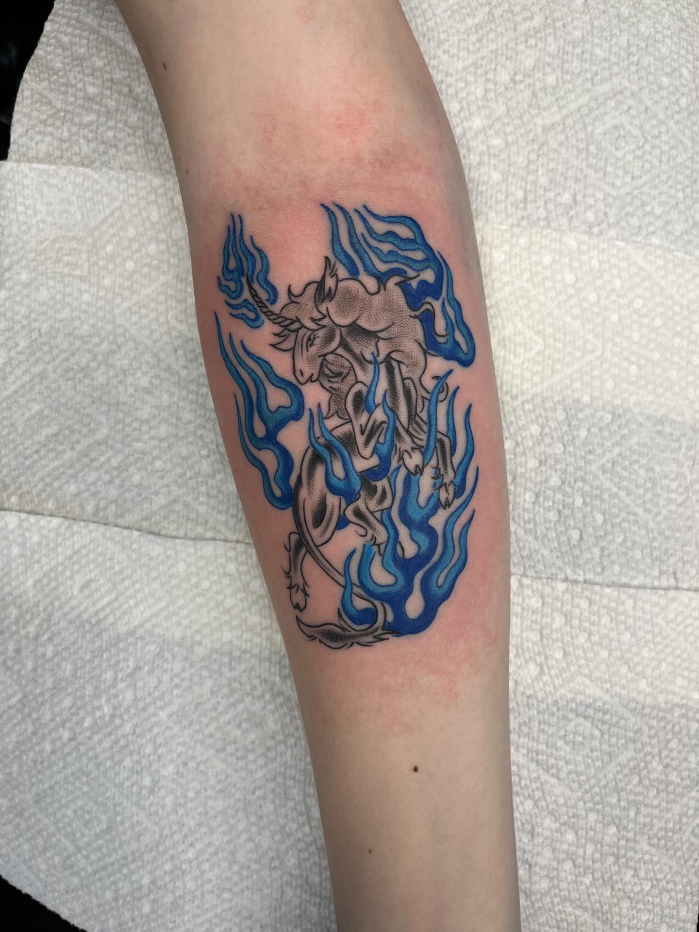 Unicorn new school tattoo on the forearm by Evan Voelker