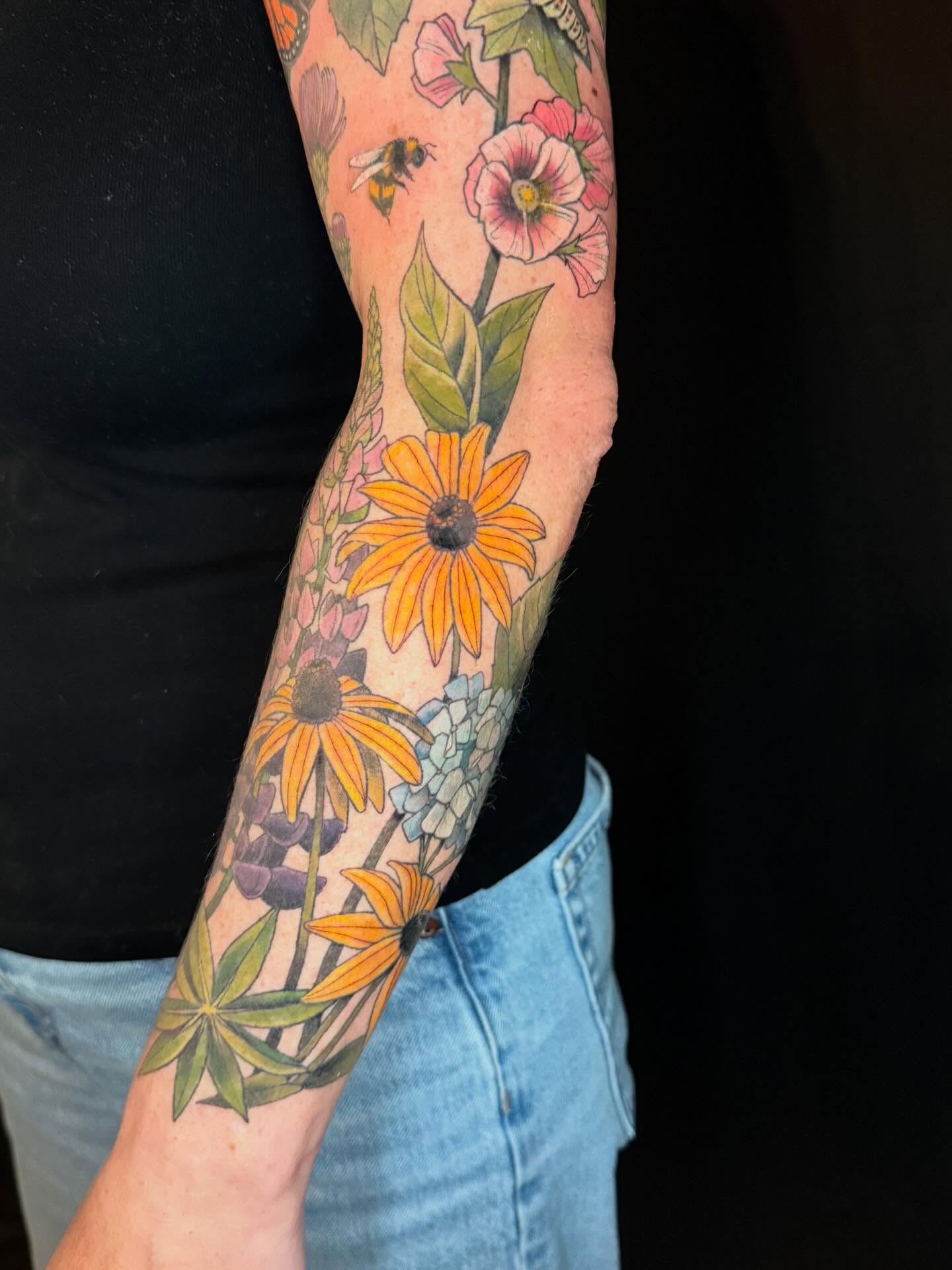 Floral bouquet new school tattoo on the forearm by Katy Bisby