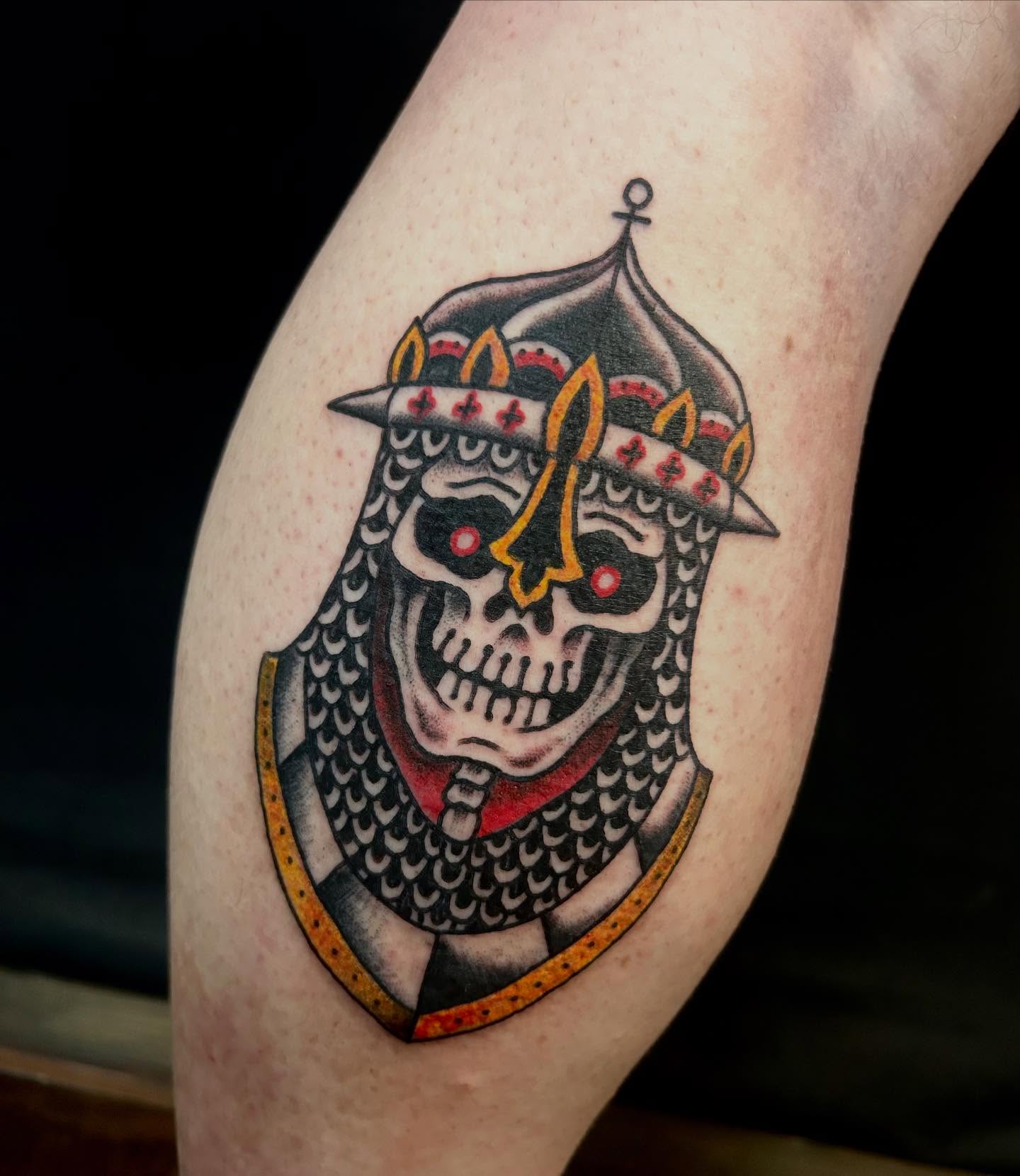 Skull in armor American traditional tattoo on the thigh by Jesse Boss, Nashville, Tennessee