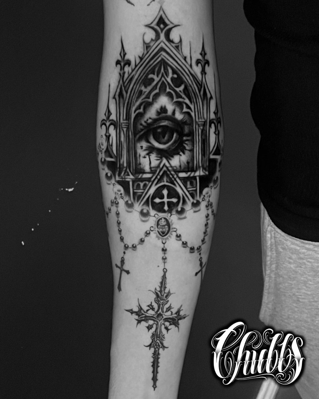 Eye and cross geometric tattoo on the forearm by Chubbs