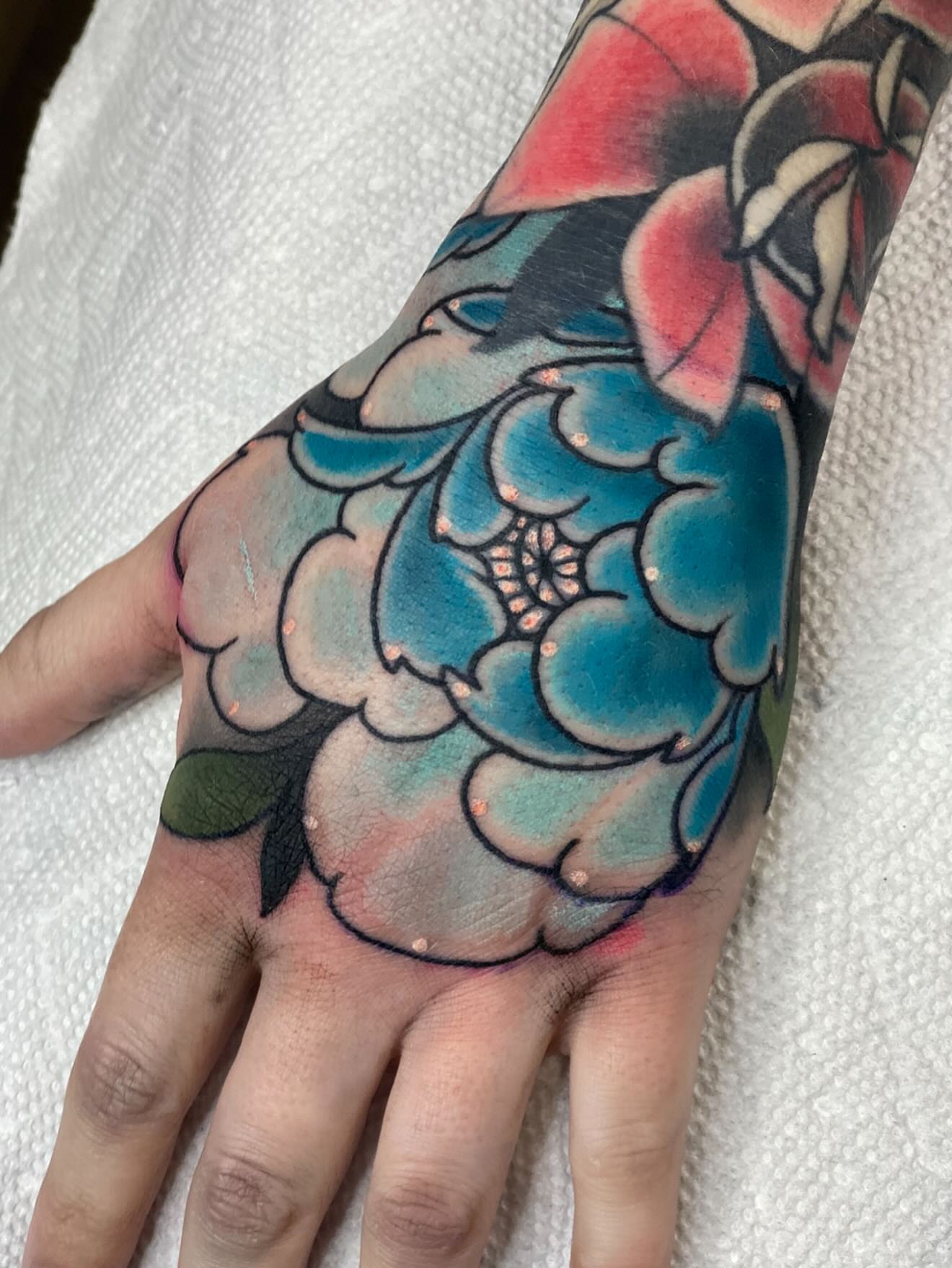 Floral bouquet American traditional tattoo on the hand by Kyle Behr