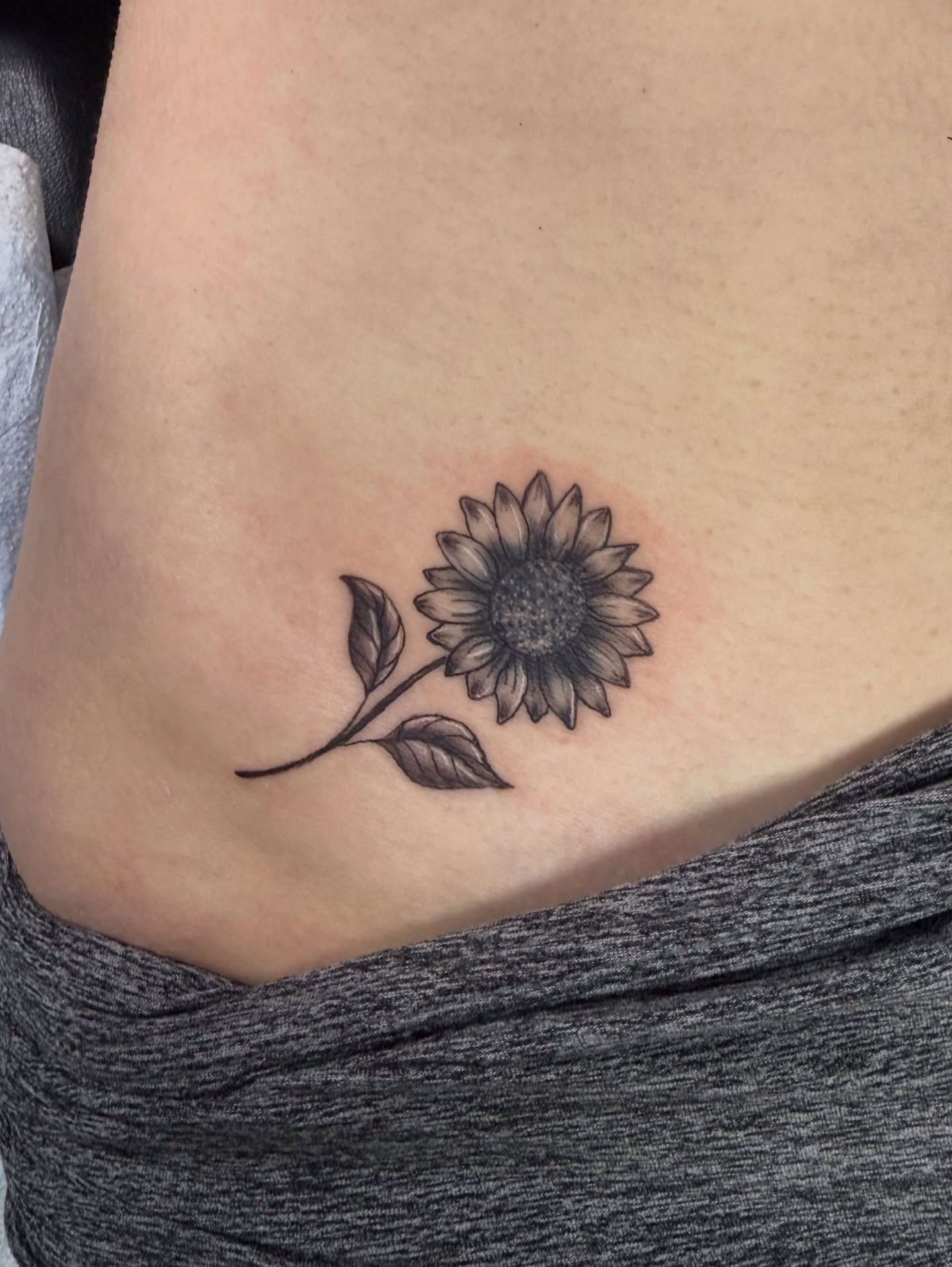 Sunflower black and grey tattoo on the ribs by Ignacio José Sweeney Rolón Bas Santa Cruz