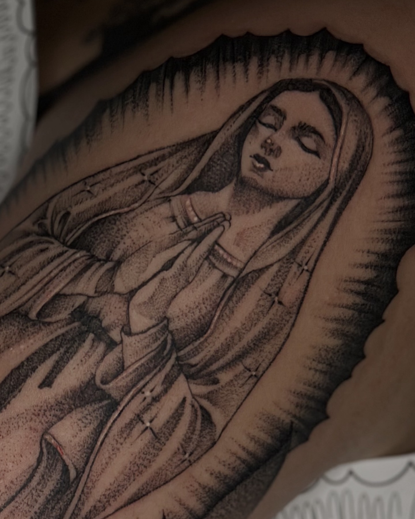 Religious figure black and grey tattoo on the upper arm by 💞Juju💕