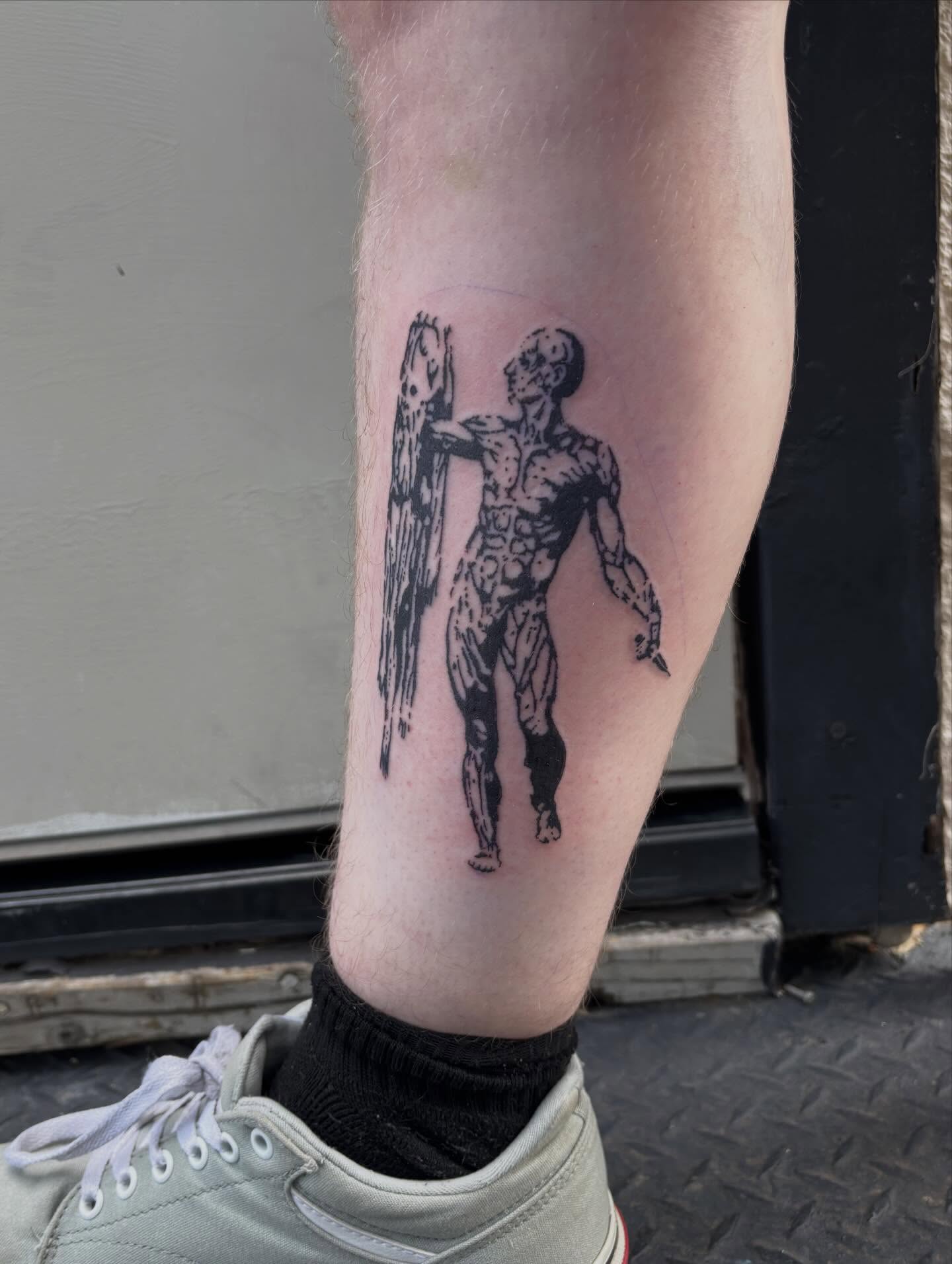 Man with fish black and grey tattoo on the forearm by Turner