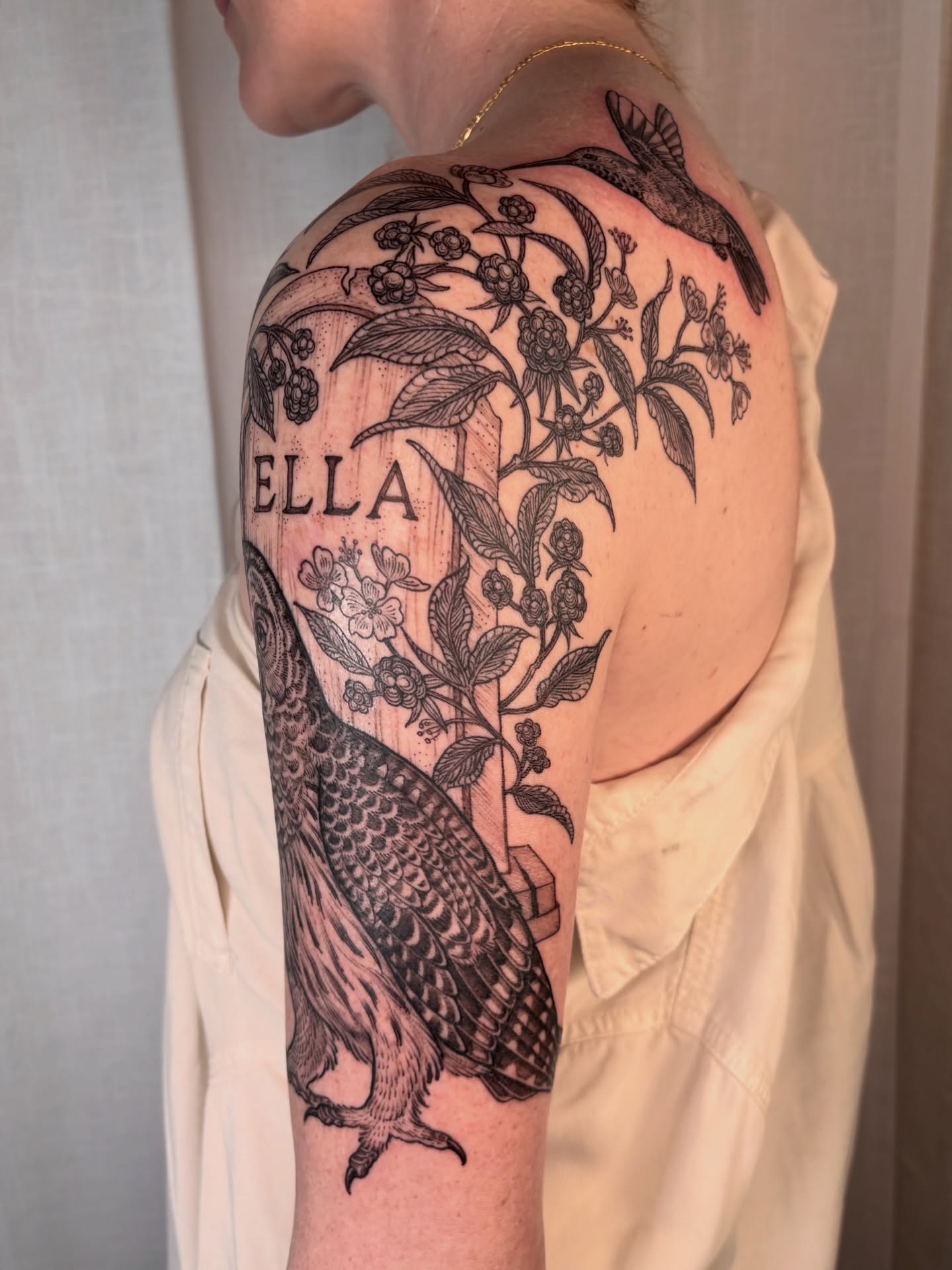 Bird and floral realism tattoo on the shoulder by Maggie