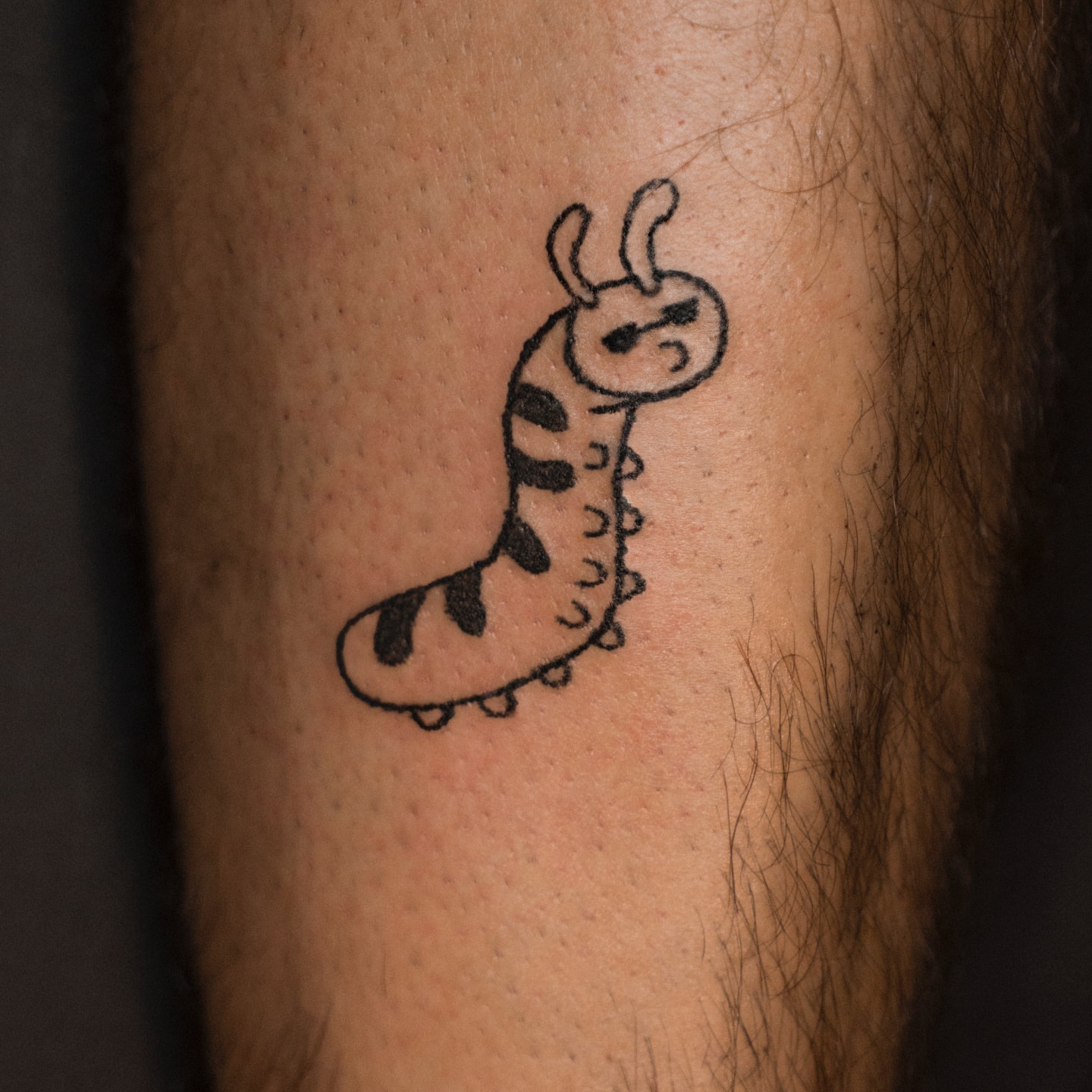 Worm black and grey tattoo on the forearm by Flash Boom Bang Tattoo