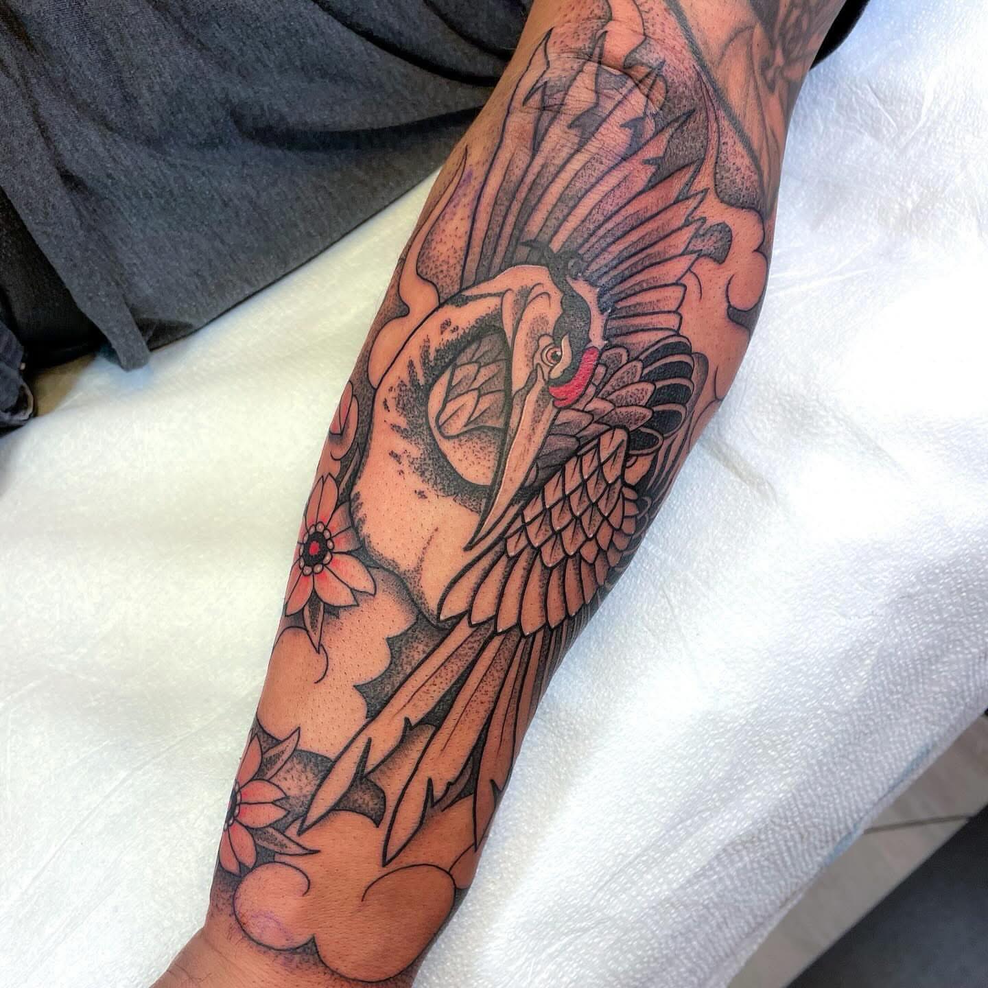 Bird and flowers American traditional tattoo on the forearm by Dev Z