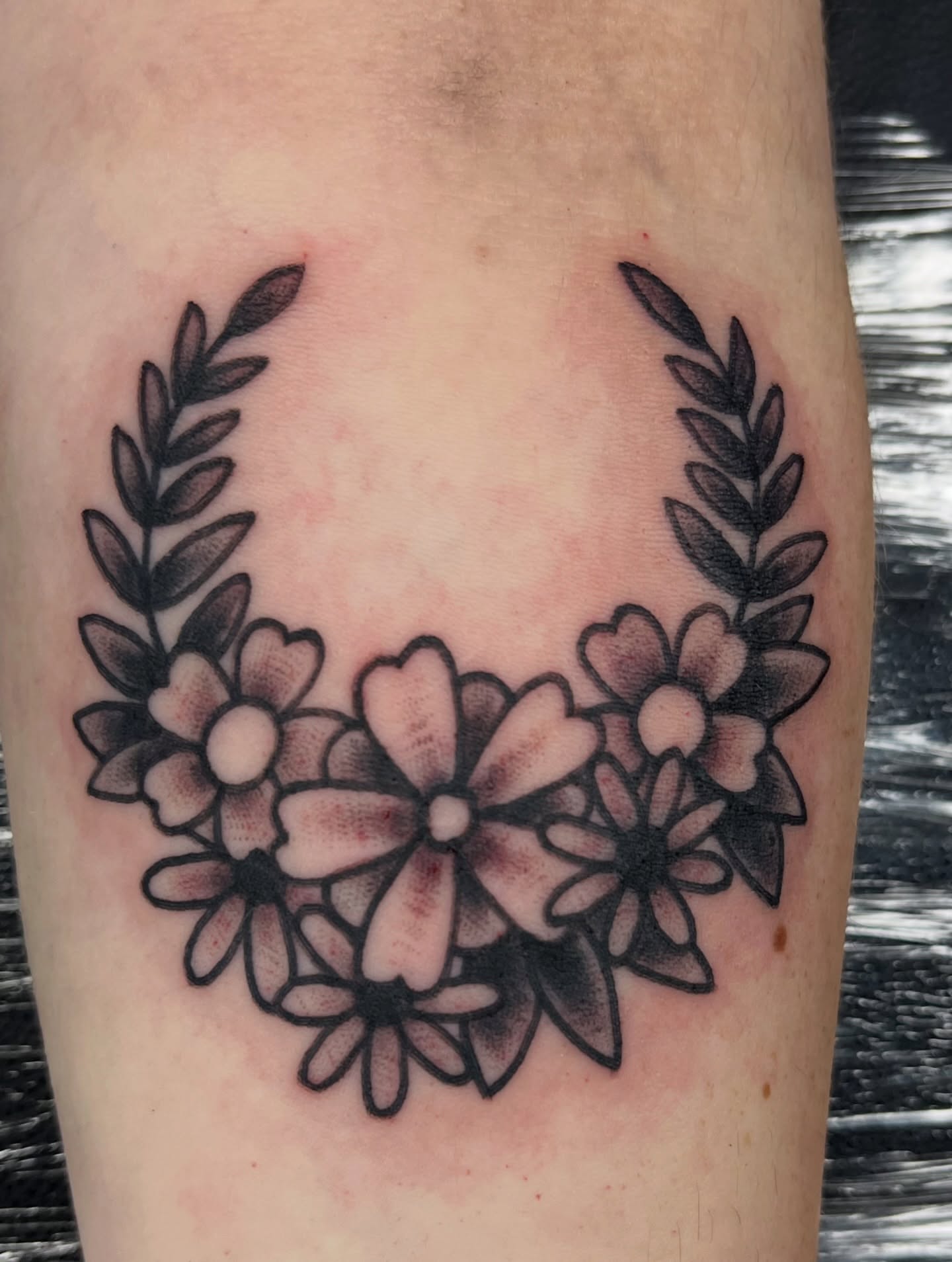 Floral wreath black and grey tattoo on the forearm by You’ll save me in your phone as Tattoo Tim