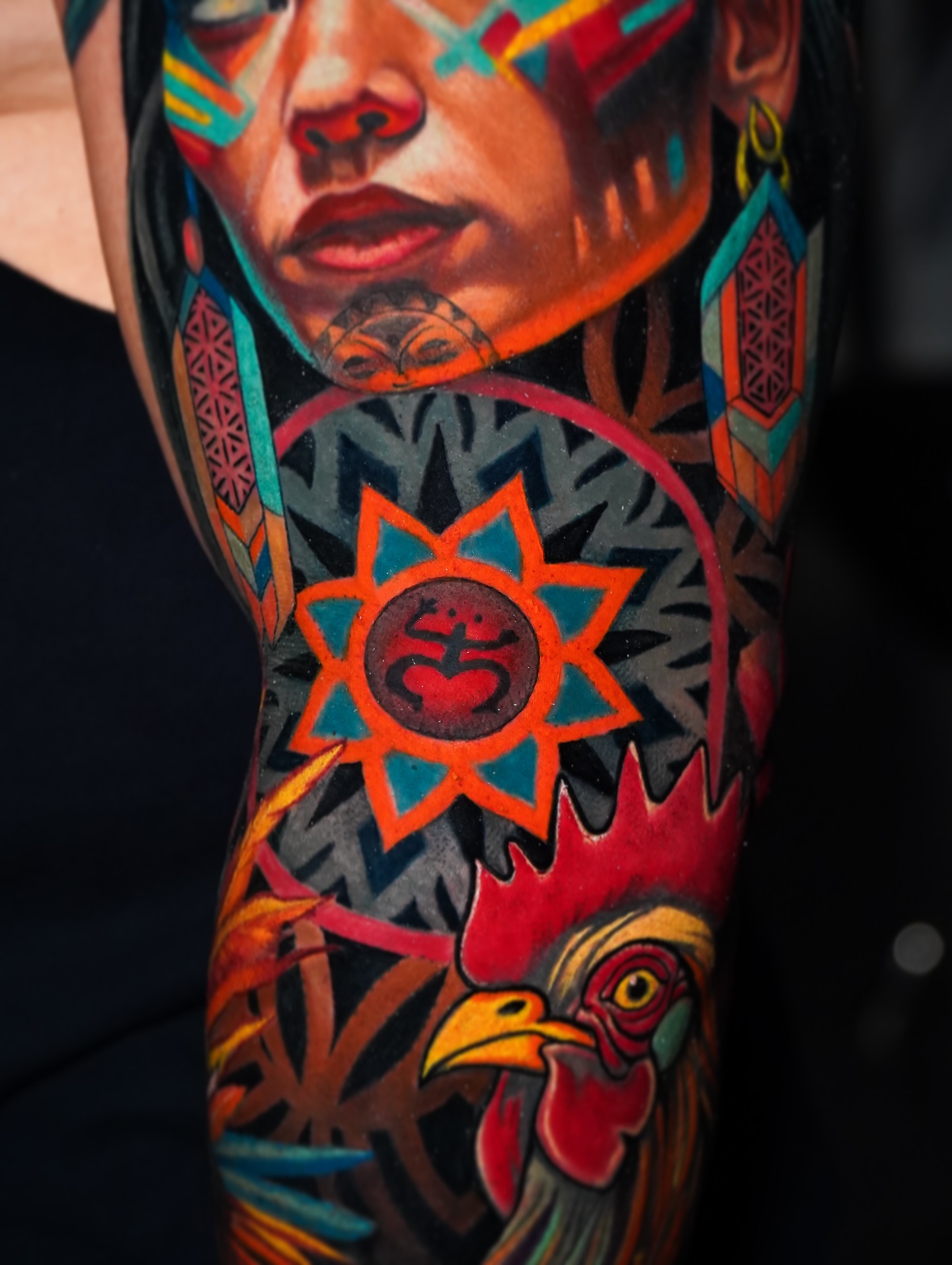 Rooster and sun geometric tattoo on the forearm by Luis Gil