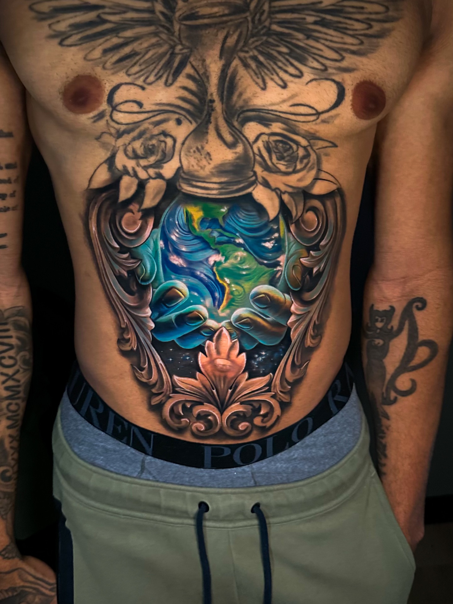 World in a jar realism tattoo on the torso by Omar Sheriff Herrera