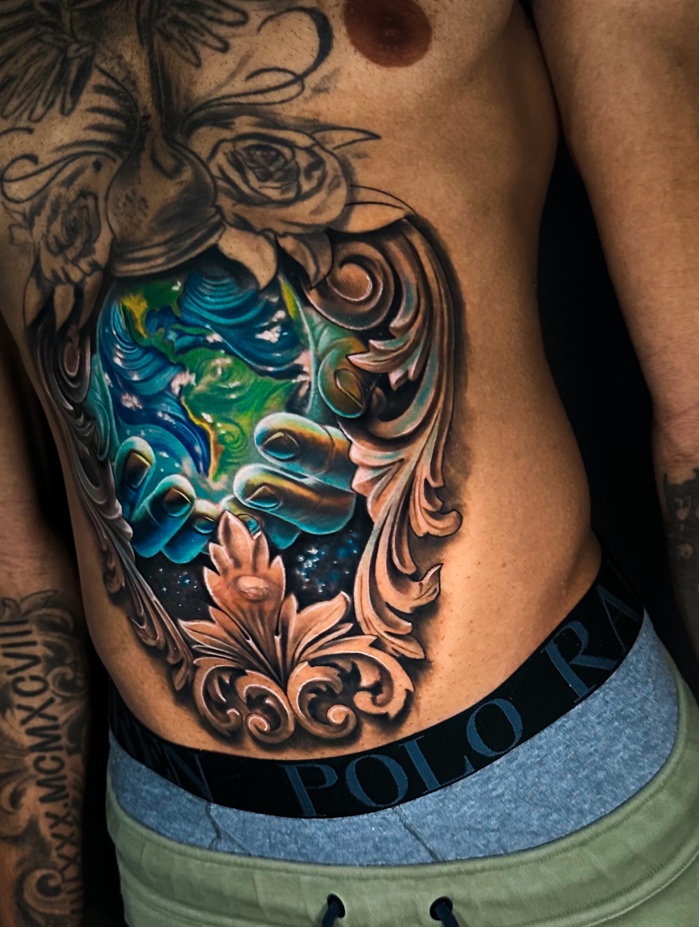 World map realism tattoo on the ribs by Omar Sheriff Herrera