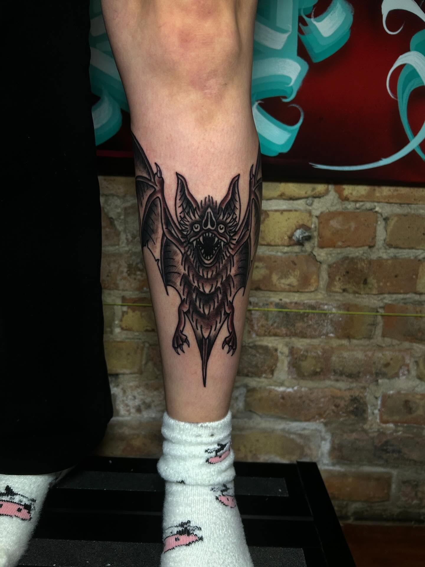 Bat black and grey tattoo on the calf by Alycia