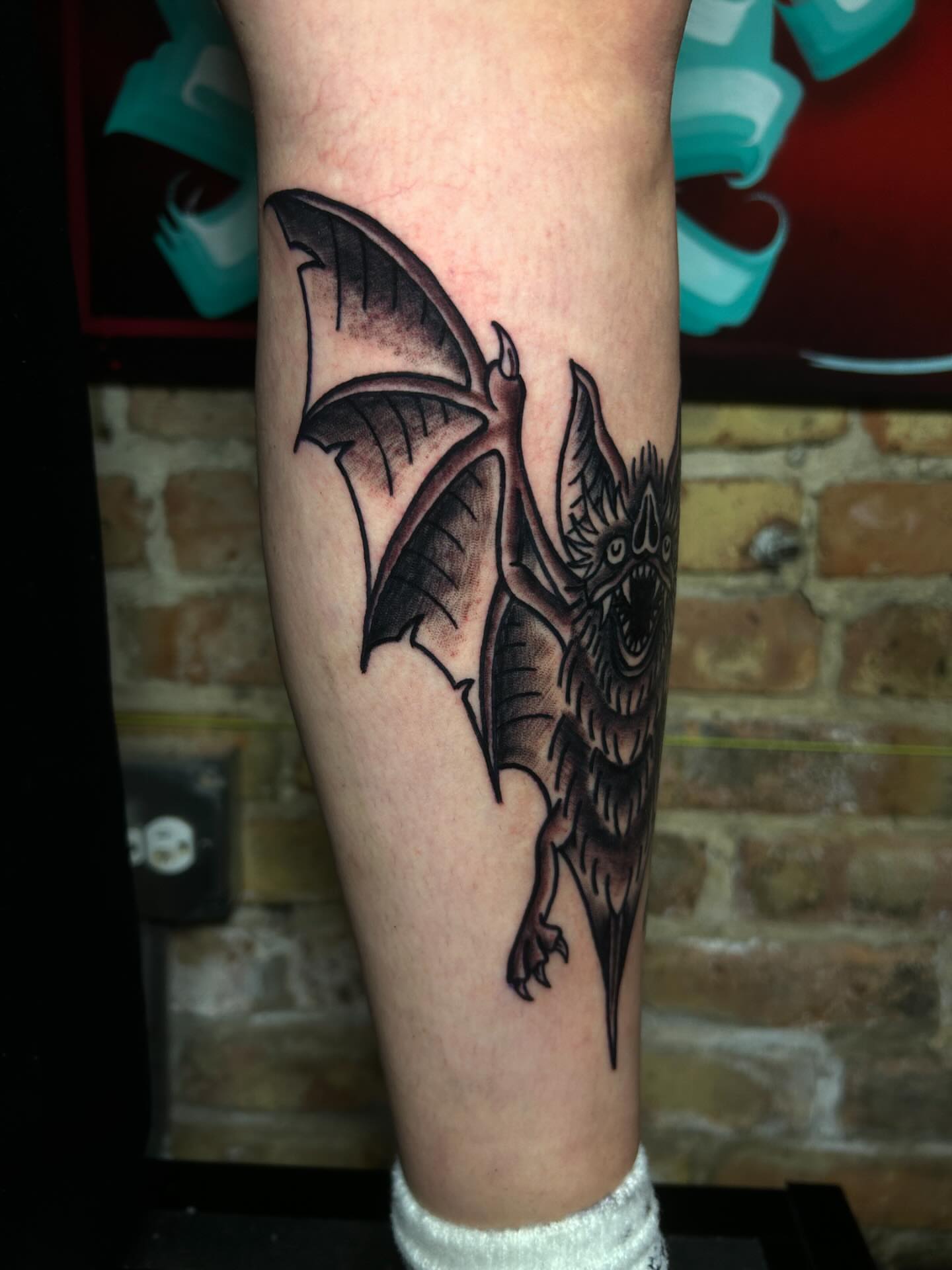 Bat black and grey tattoo on the forearm by Alycia