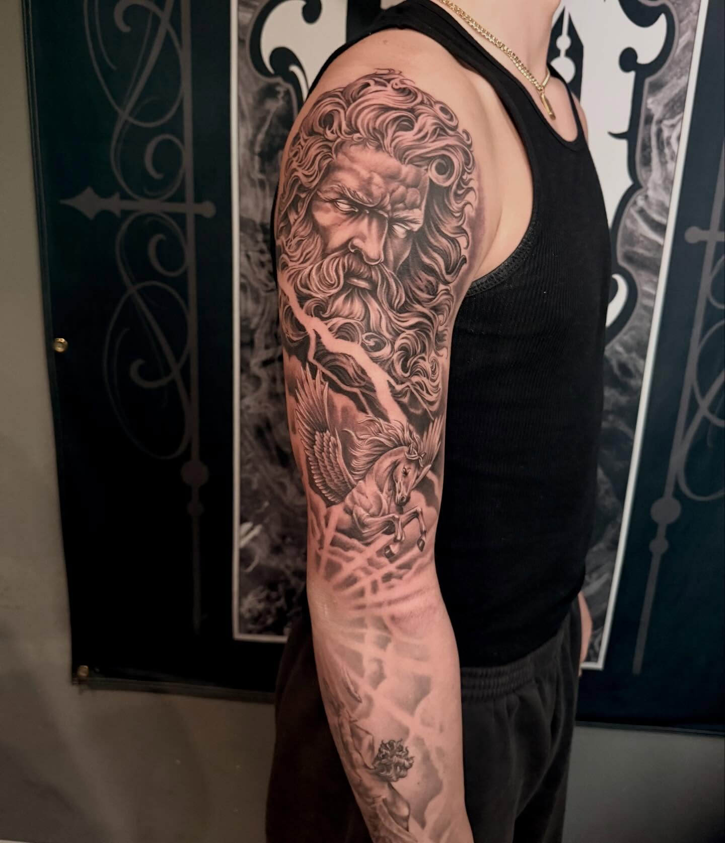 God-like figure with bird realism tattoo on the upper arm by Cody Pappas