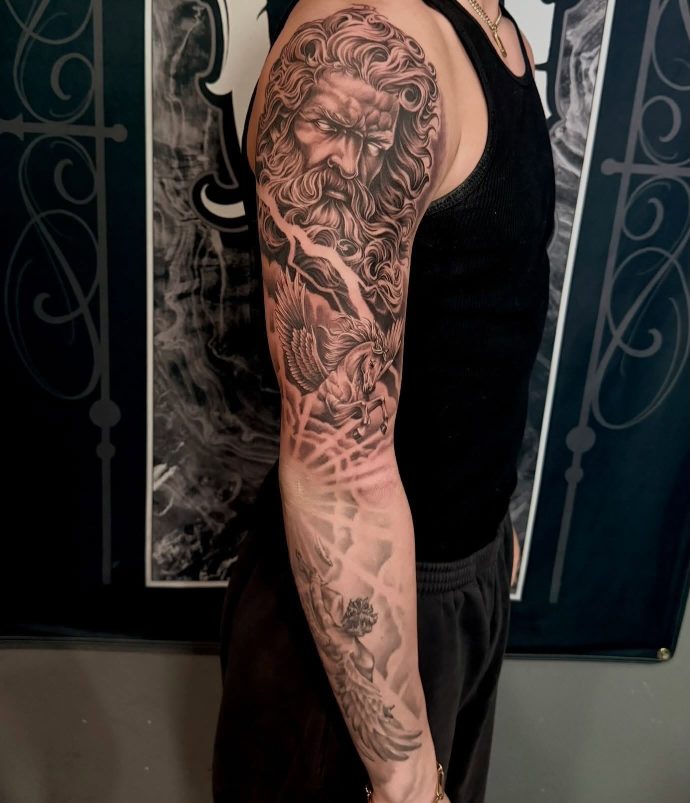 God-like figure with bird realism tattoo on the forearm by Cody Pappas