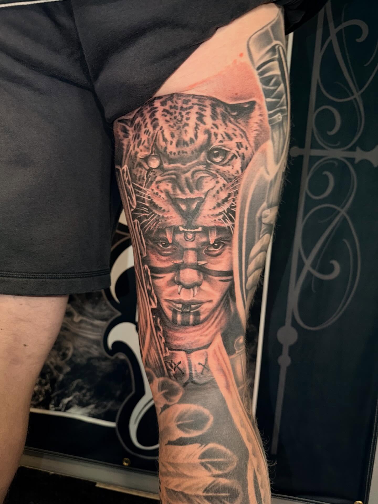 Indian chief with leopard realism tattoo on the forearm by Cody Pappas