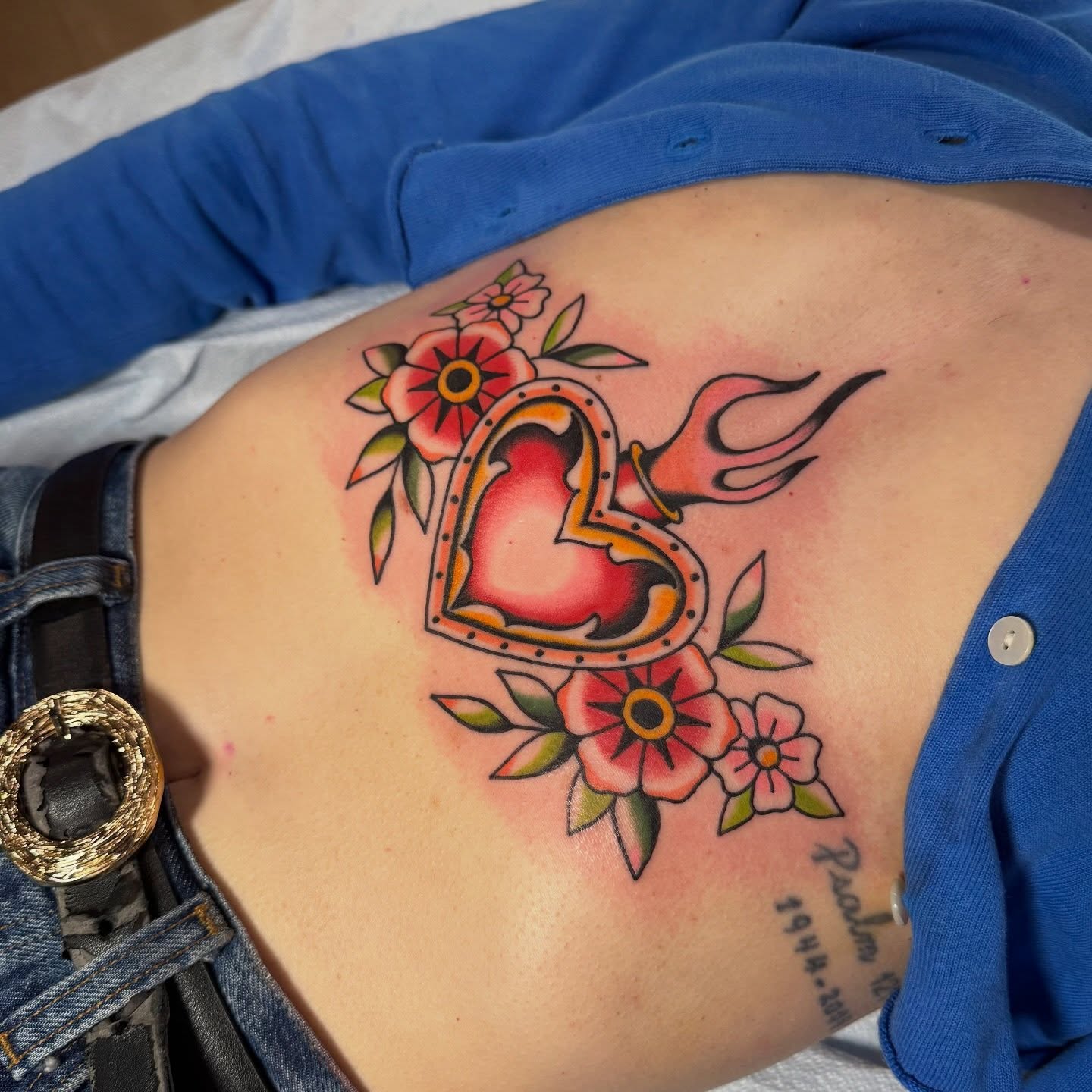 Heart with flowers American traditional tattoo on the ribs by Kaley, Des Moines, Iowa