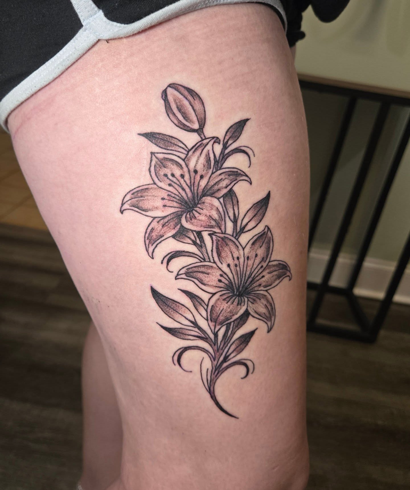 Lilies black and grey tattoo on the thigh by Matt Page