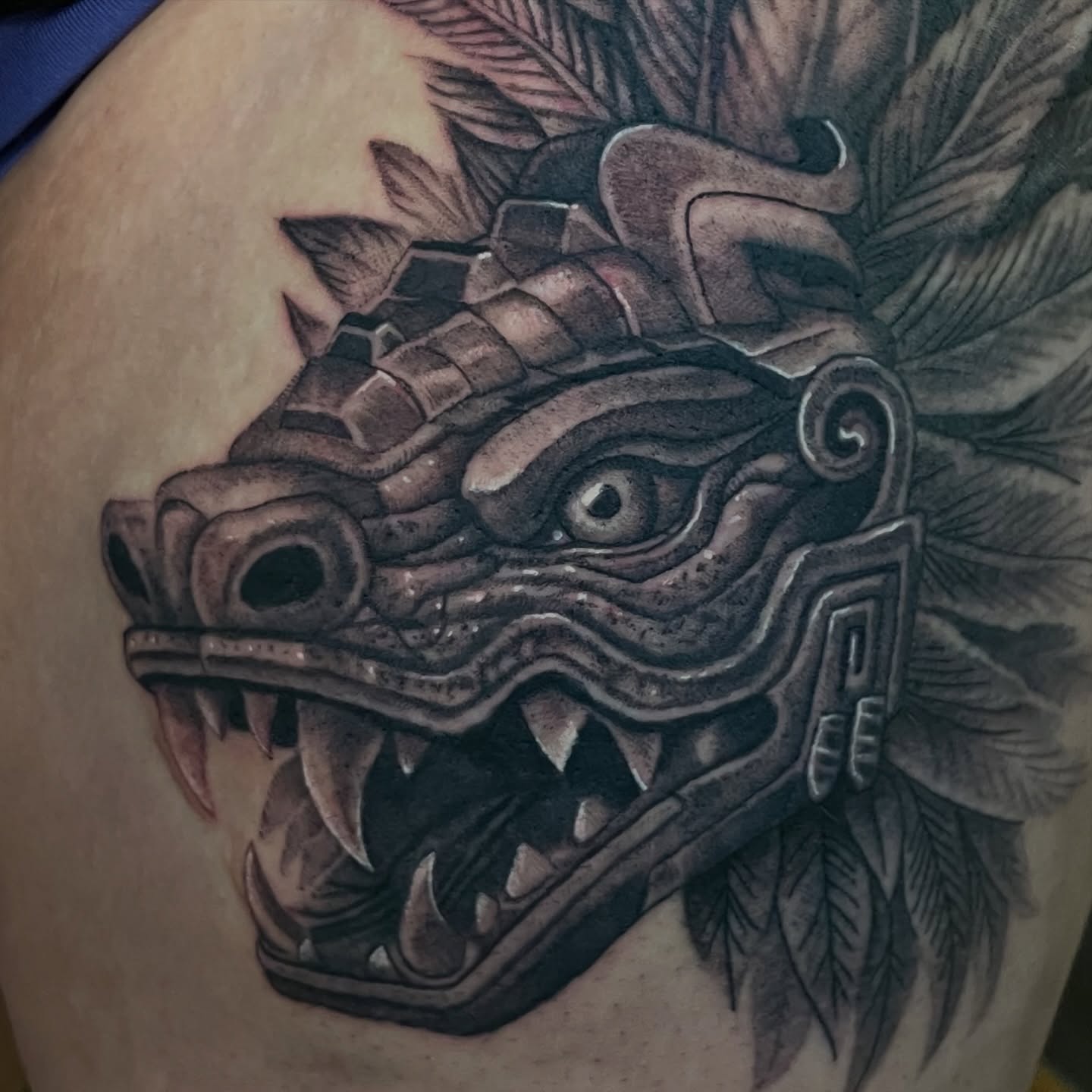 Serpent mask realism tattoo on the shoulder by Zachary Hayden