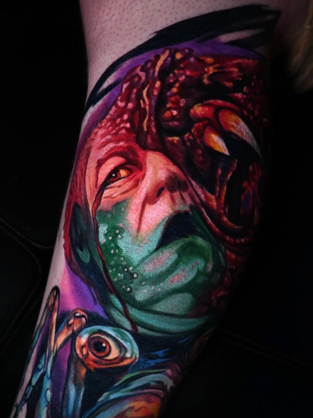 Creature face with eye surrealism tattoo on the forearm by William Pollock
