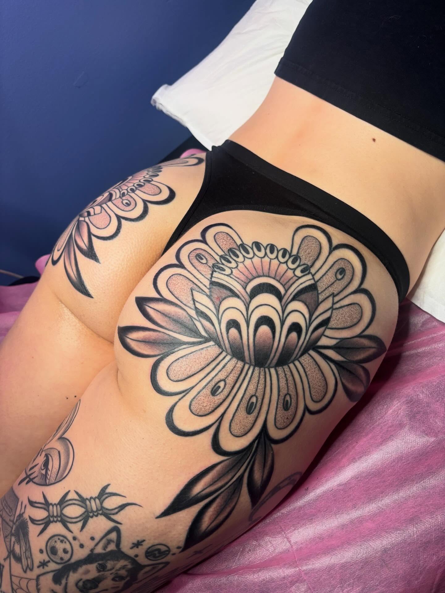 Floral design black and grey tattoo on the thigh by Victoria Bacon
