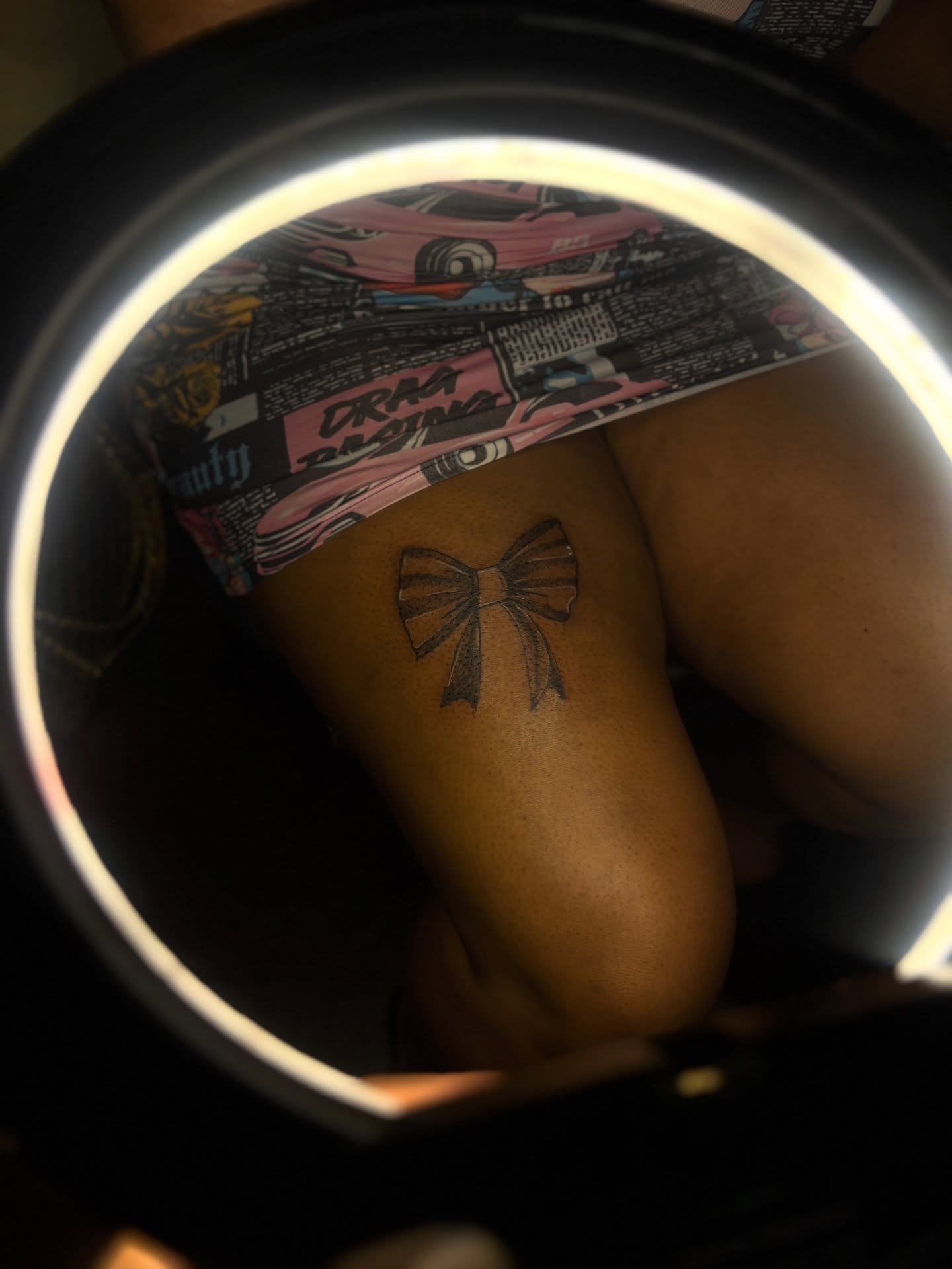 Bow black and grey tattoo on the thigh by Winter j