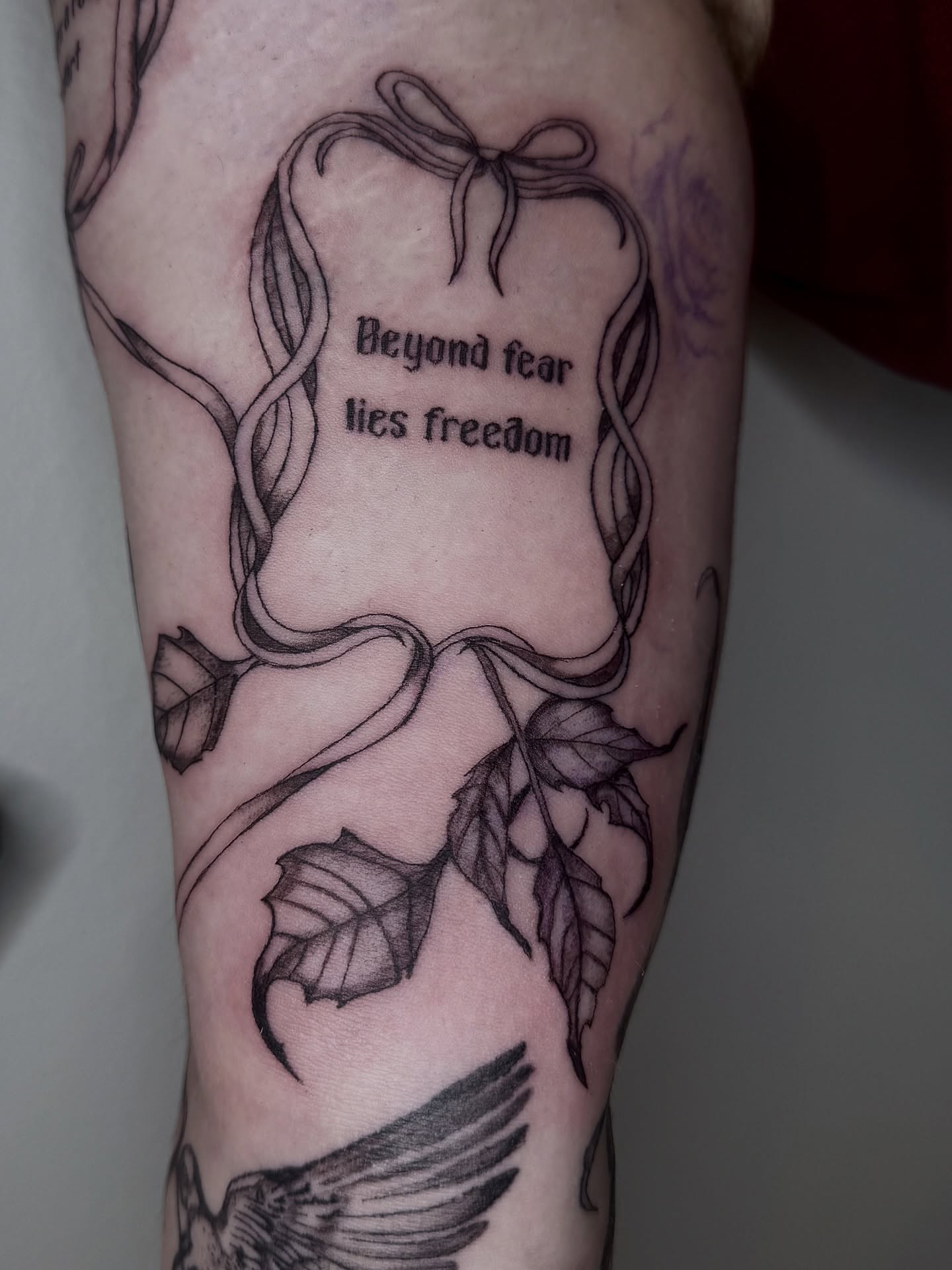 Beyond fear lies freedom black and grey tattoo on the forearm by dev