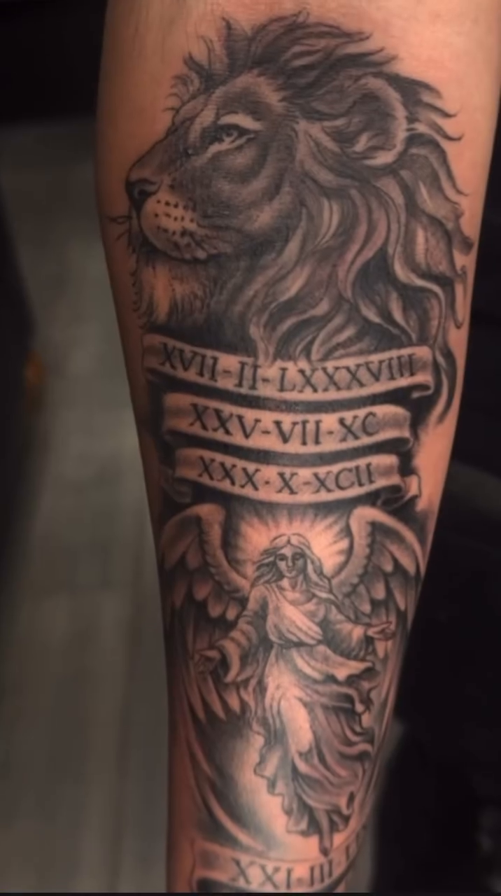 Lion and angel with roman numerals Chicano tattoo on the forearm by Greg Romero (el chamo), Millcreek, Utah