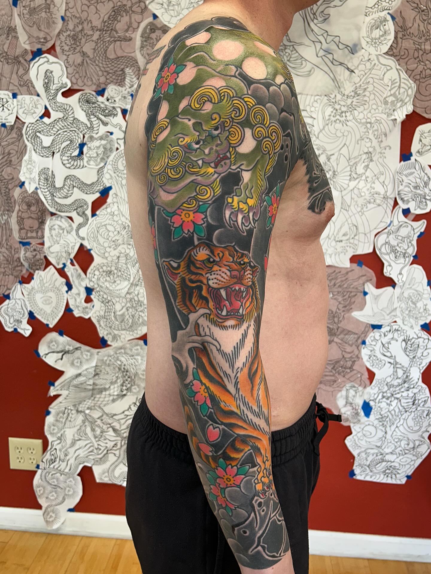 Tiger and dragon japanese irezumi tattoo on the upper arm by Matthew Crimson